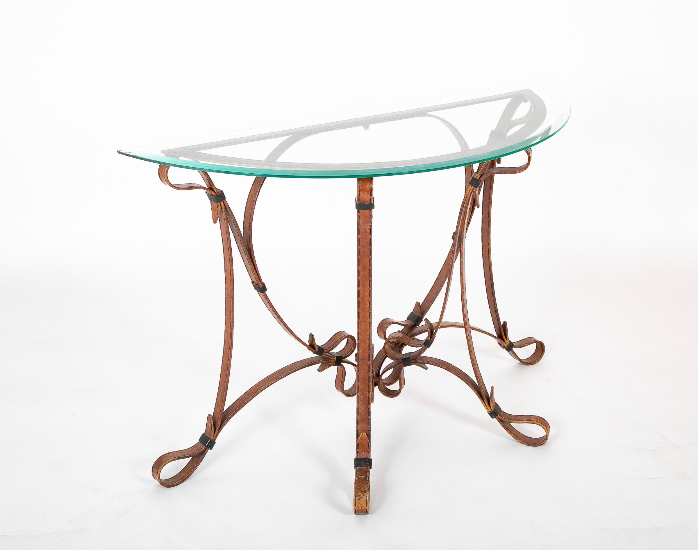 Unusual and quite attractive wrought iron console table with a faux leather finish imitating belt-like straps curling and intersecting to make up the base. A very realistic finish, down to the faux stitching running along the straps. A custom piece