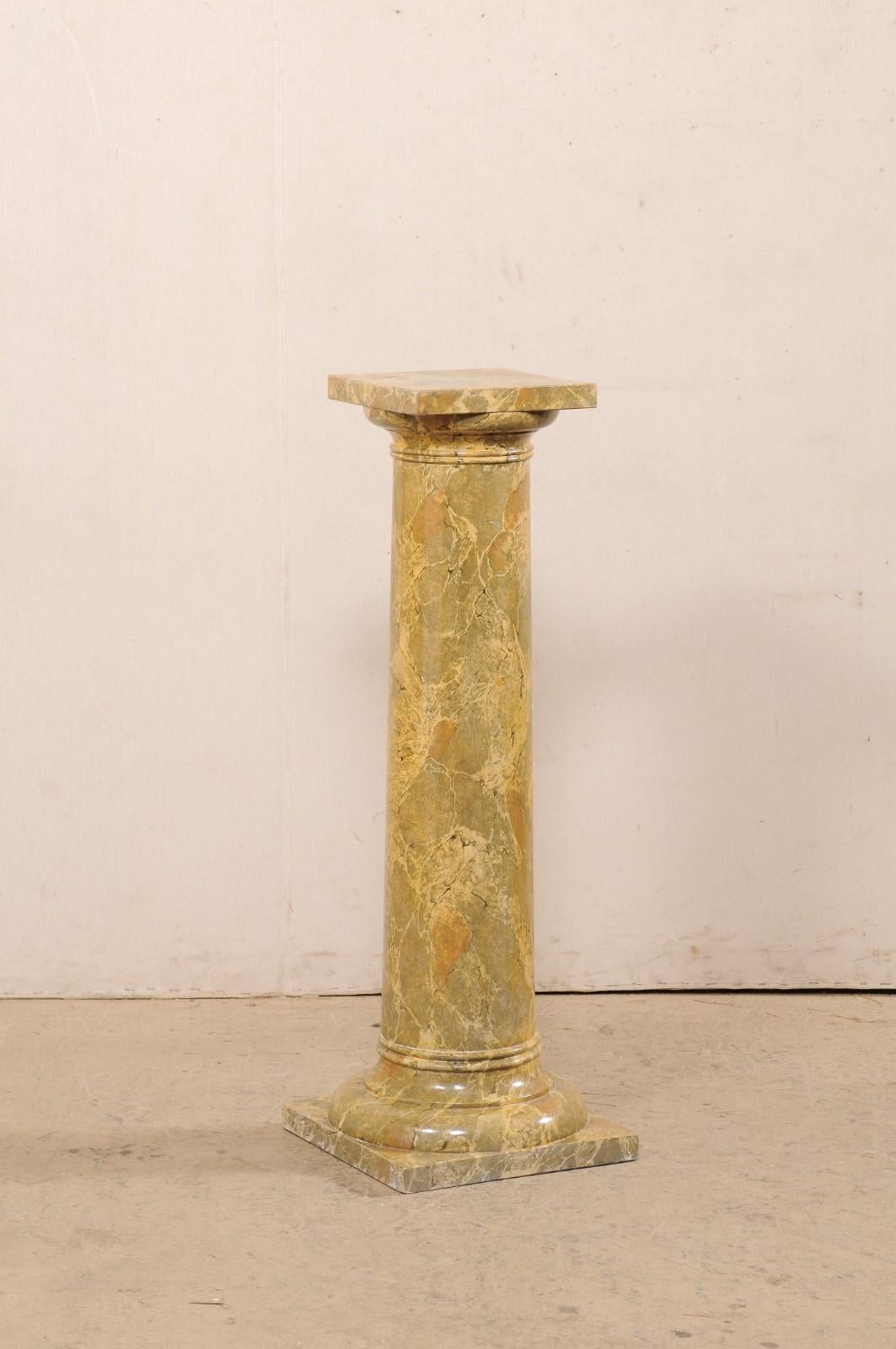 A French faux-marble painted wood column from the mid 20th century. This vintage pedestal from France has a round-shaped column body, with a squared top. Circular banding/molding is found just beneath the top and repeated at bottom, where it is
