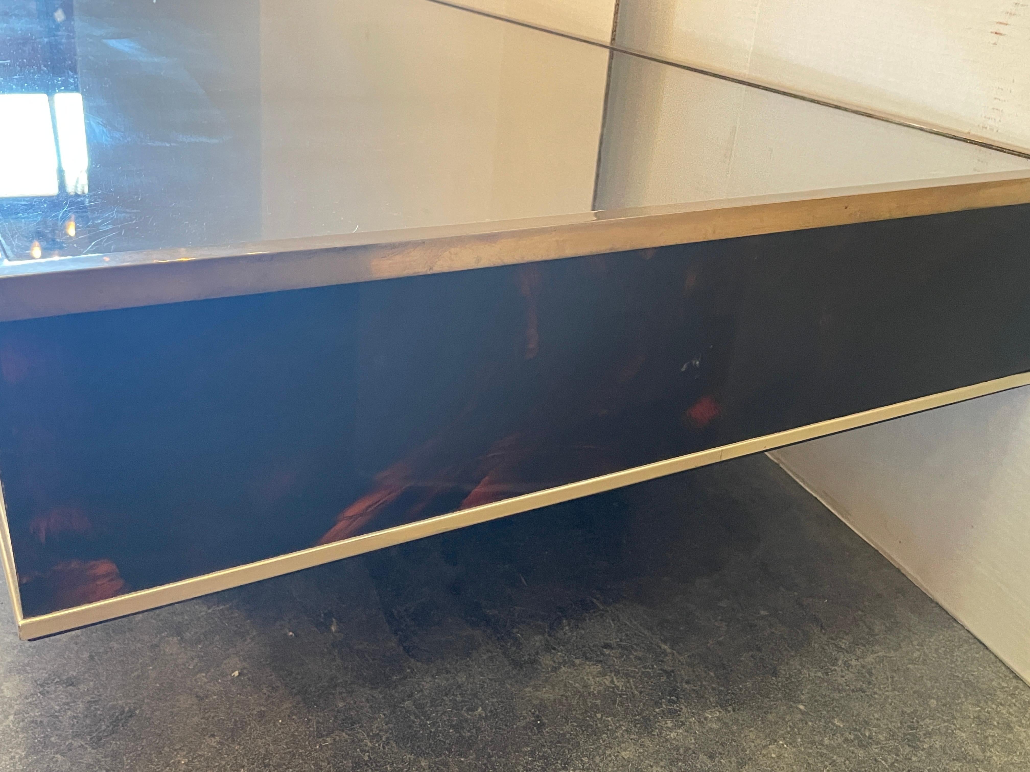 1970s French design faux tortoiseshell plexiglass coffee table with brass trim and signature inset. This is a very handsome tortoiseshell pattern.  The color is so rich and would elevate any room.
47.5 w x 24 d x 13.1/8 t