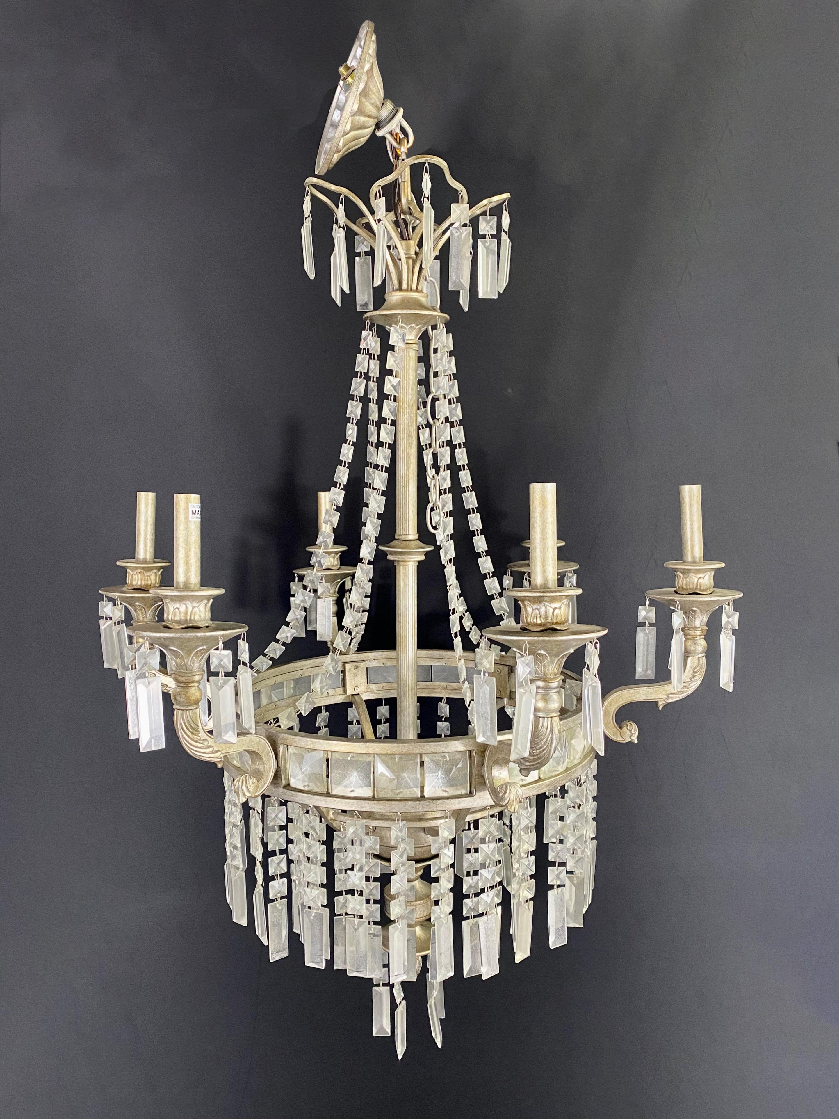 A stylish French federal style chandelier made in antiqued fashion. The metal frame has a beautiful pewter antique finish. The chandelier is embellished with triangle lucite prisms also having a white antiqued finish. The chandelier hosts 6