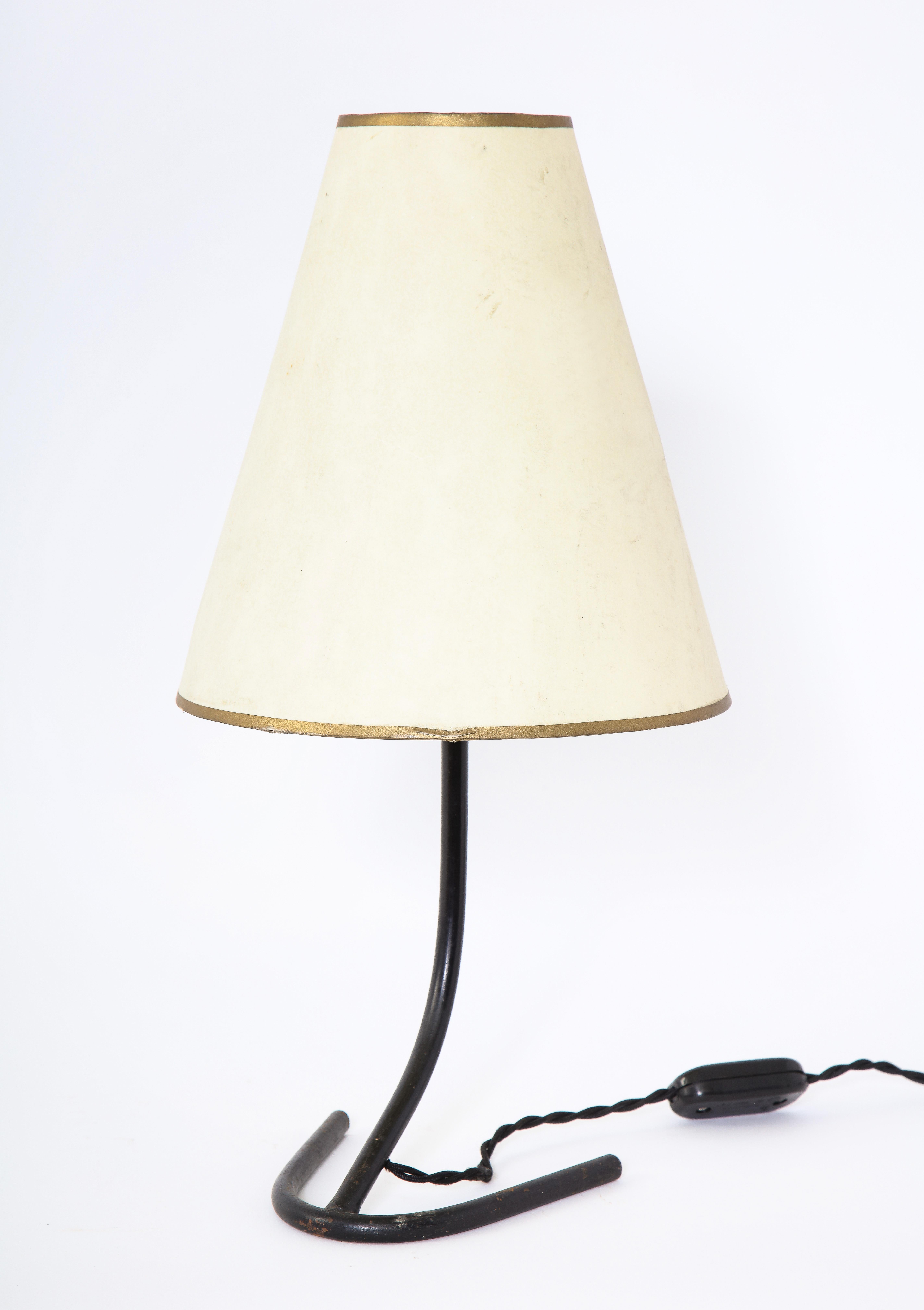 A diminutive bedside or desk lamp in blackened wrought iron. Rewired.