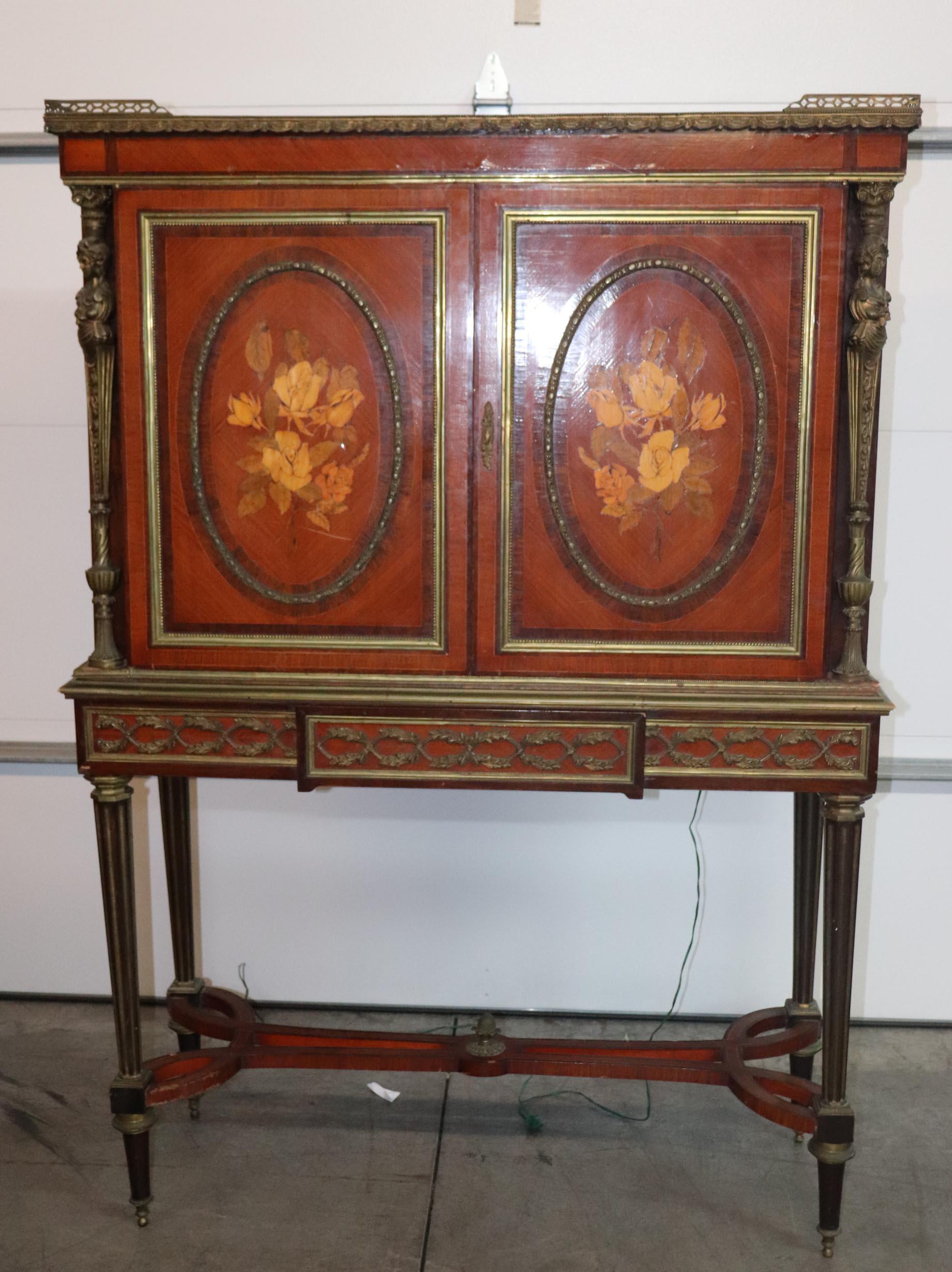This is a stunning 1900s era (1890-1920) vitrine or collector's cabinet designed in the manner of Adam Weisweiler one of France's best known cabinetmakers who frequently used figural maidens and copious amounts of inlay and bronze. The piece is in