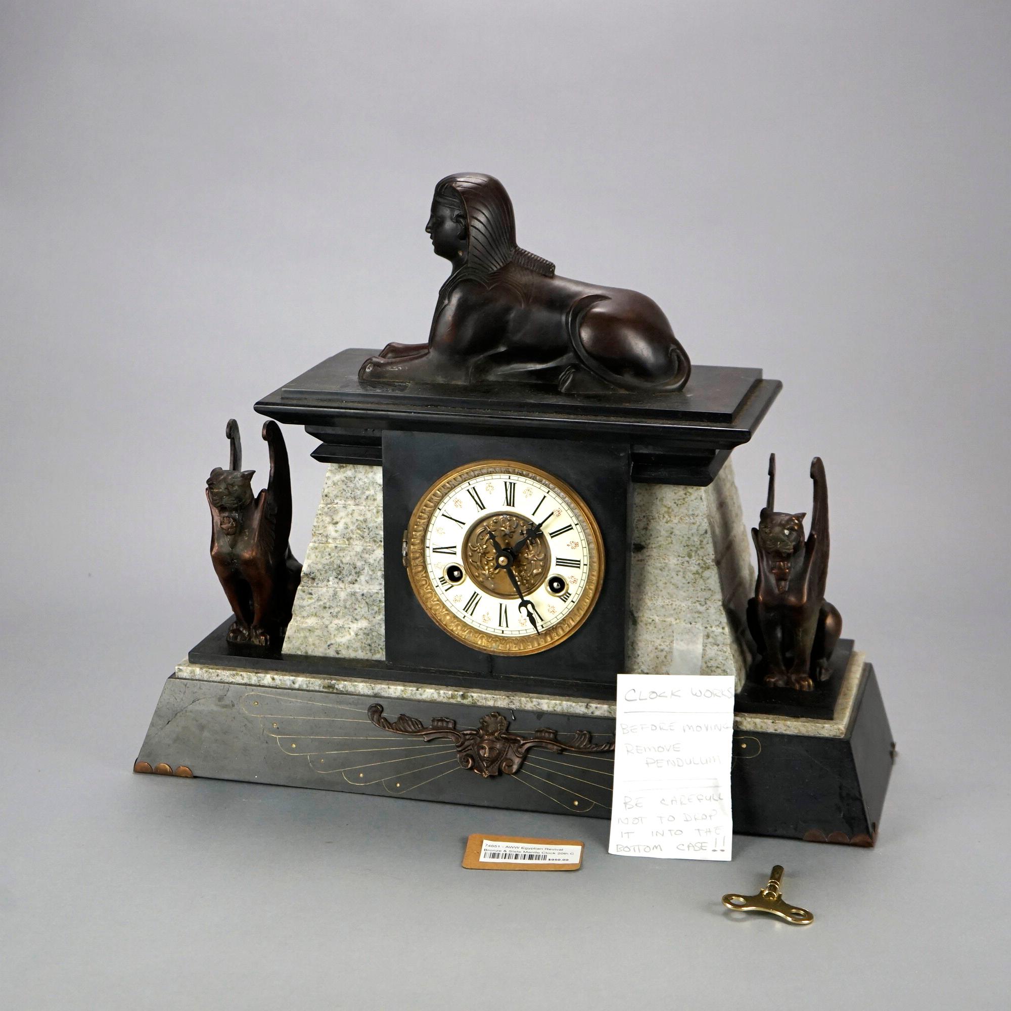 A French figural Egyptian Revival mantel clock offers cast bronze sphinx over slate and marble clock with flanking griffins, working condition, 20th century

Measures- 16''H x 20''W x 7''D.

Catalogue Note: Ask about DISCOUNTED DELIVERY RATES