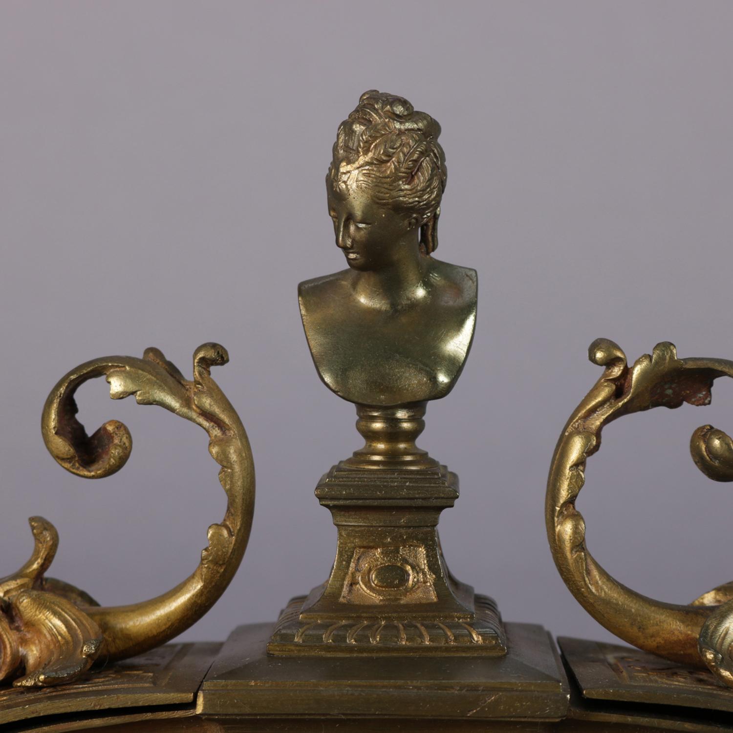 Antique French bronzed metal figural double inkwell features embossed scroll and foliate decoration with central bust of Marie Antoinette and flanking inkwells having figural dolphin handles, seated on stepped and footed base, circa