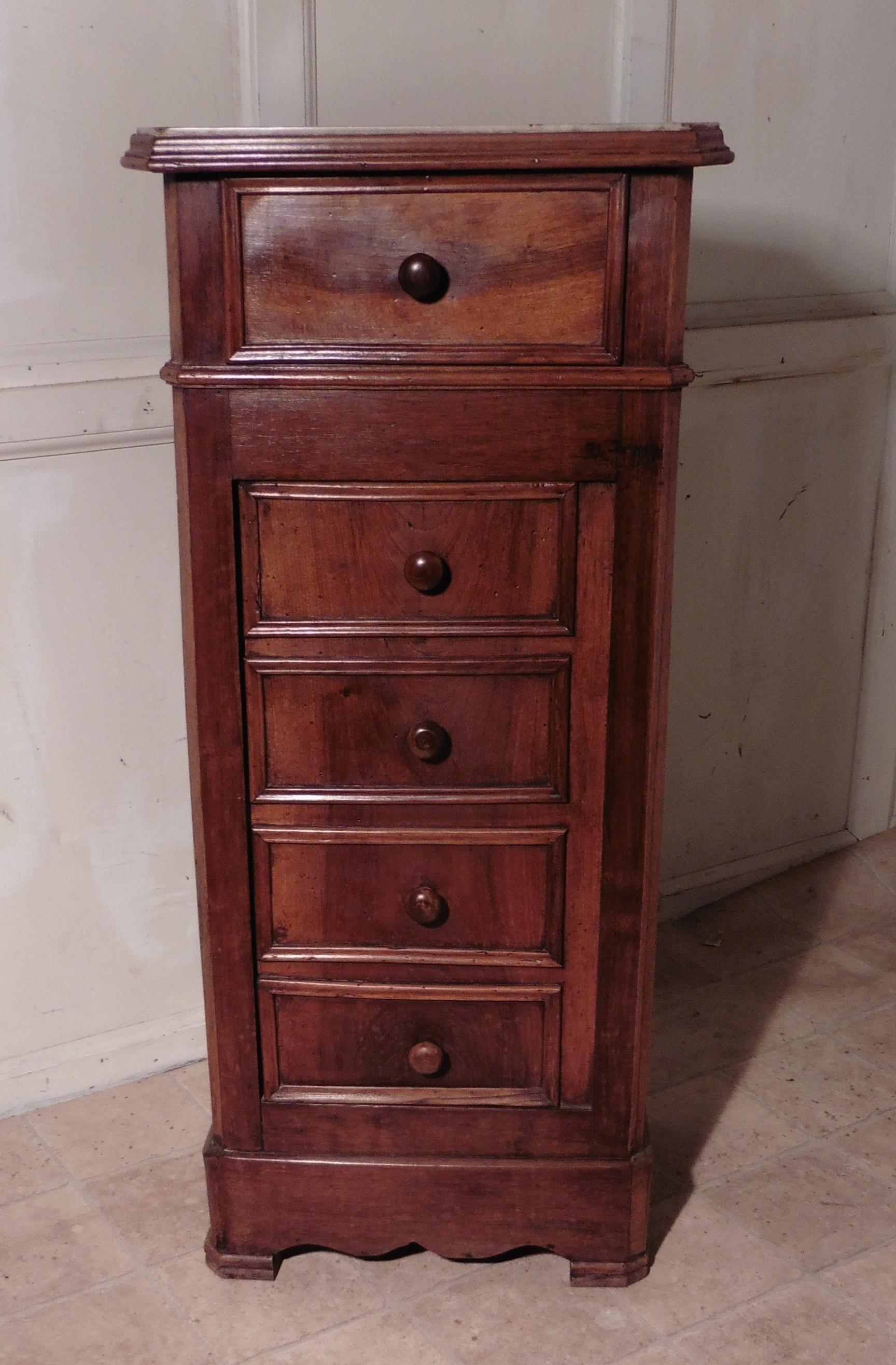 French Figured Walnut Bedside Chest of Drawers or Night Table

 This piece is made from beautifully figured veneers, it appears to have 5 drawers to the front, but the 4 lower drawer fronts are in fact a cupboard door enclosing a shelved cupboard