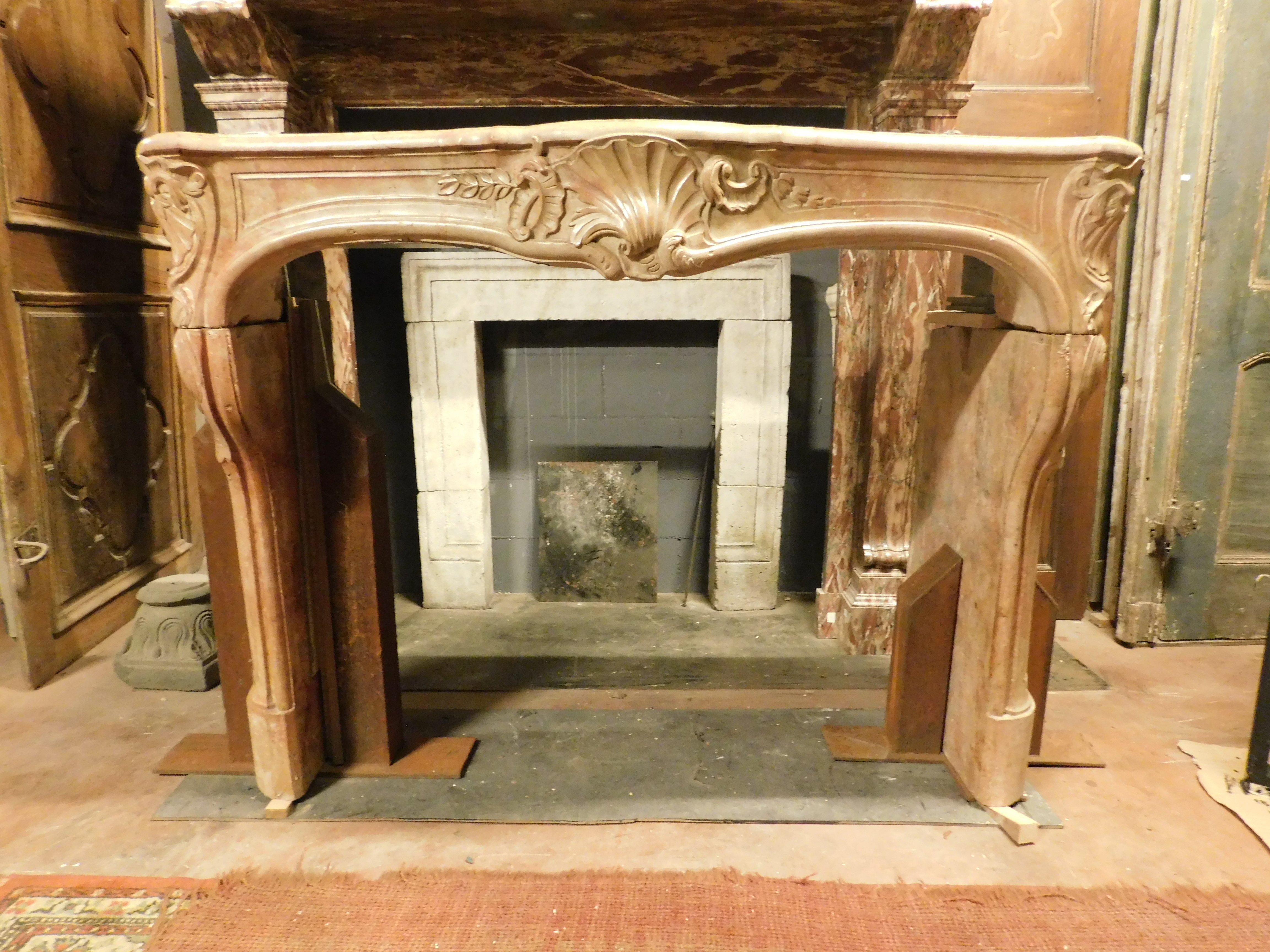 Ancient fireplace mantle, hand-sculpted with central shell and floral decorations on the legs, in precious 