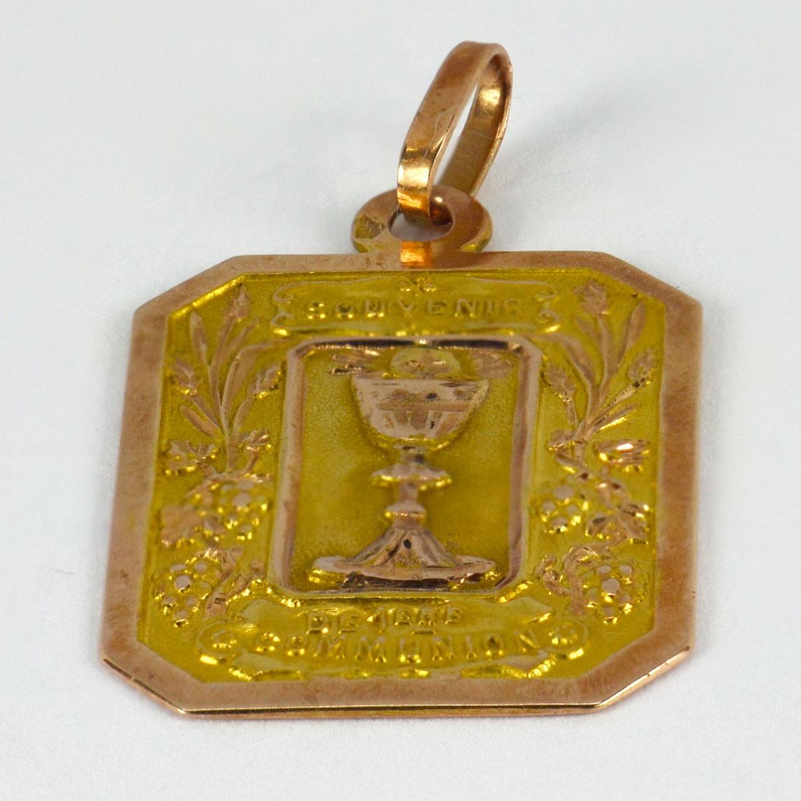 An 18 karat (18K) yellow and rose gold charm pendant depicting a goblet, engraved First Communion. Stamped with the eagle’s head for French manufacture and 18 karat gold.

Dimensions: 2.8 x 1.8 x 0.1 cm (not including jump ring)
Weight: 3.38 grams 

