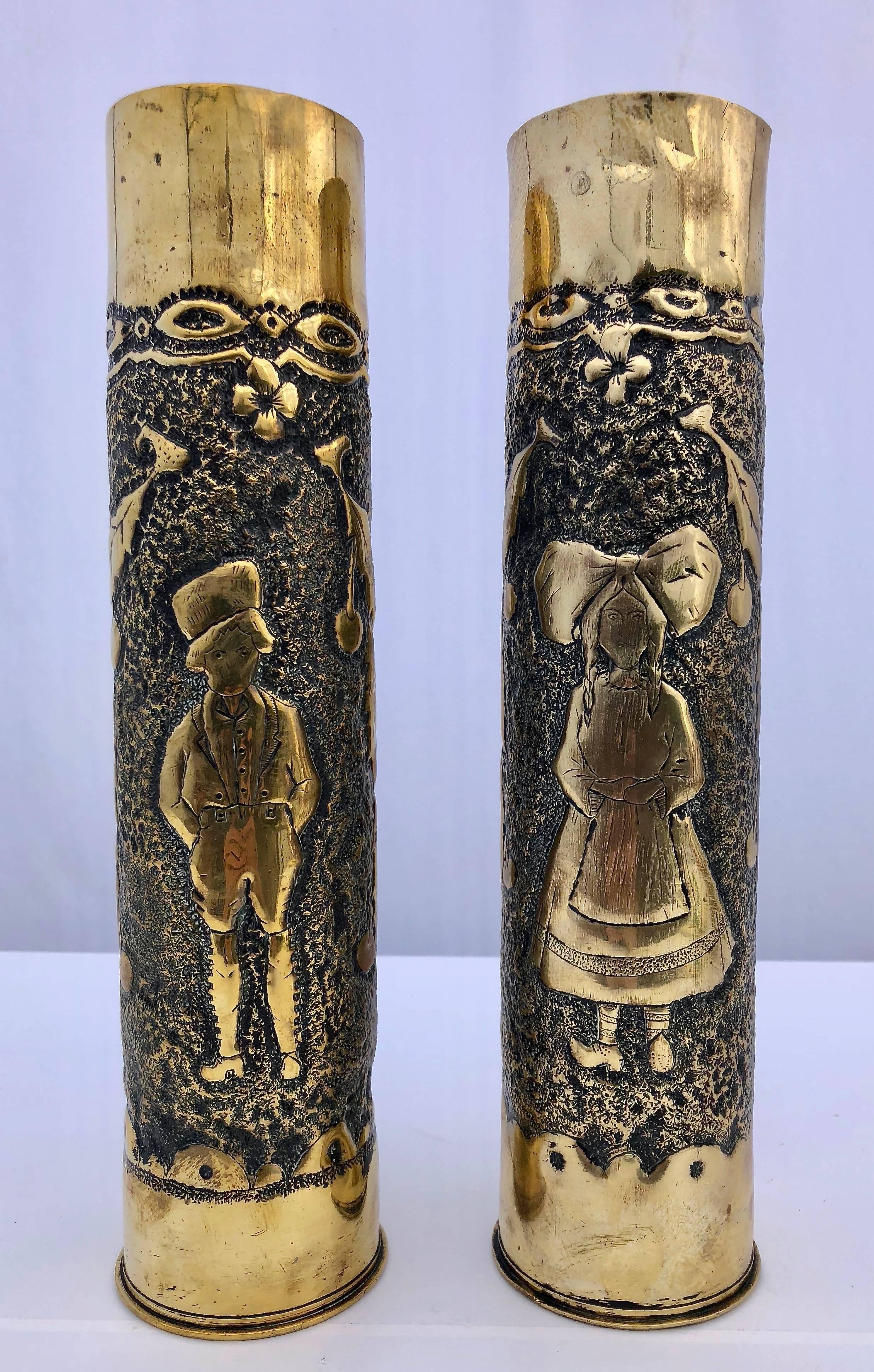 This gorgeous pair of carved brass mortar shells are of a young couple wearing traditional Lorraine or Alsace costumes with matching floral decorations. There are in great condition, especially considering their 100 year old age. To see this