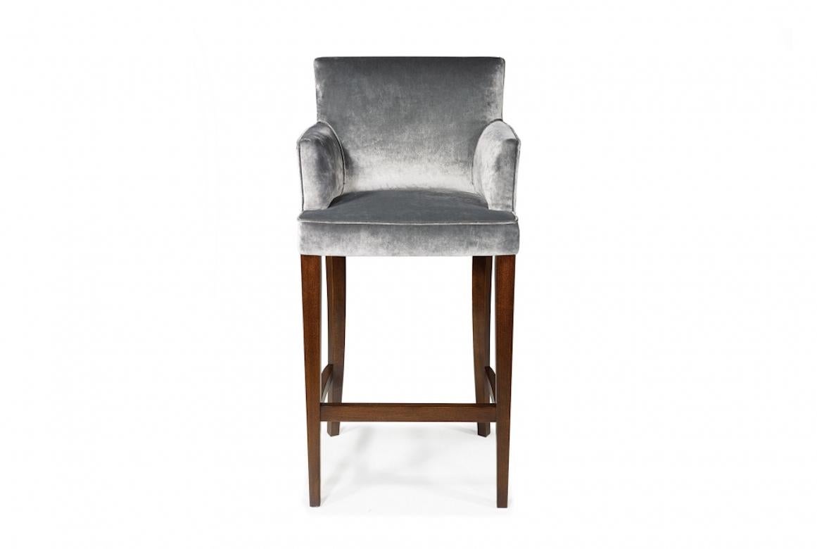 A stunning French Fitzroy stool, 20th century.

Fitzroy is an upholstered bar stool with straight legs and fully upholstered arms, shown in mahogany with a dark mahogany finish. The arm height can be adjusted to your specifications.

Handcrafted