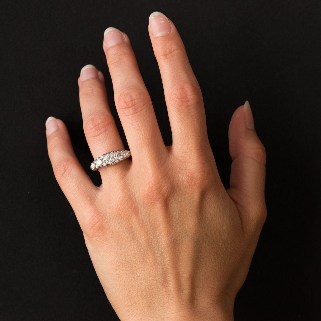Ring in 18 carat white gold, eagle head hallmark. 

This stunning and highly feminine diamond ring features 5 brilliant cut diamonds set in a row interspersed by a further 8 smaller diamonds. The curved profile is in arabesque openwork. 

Total