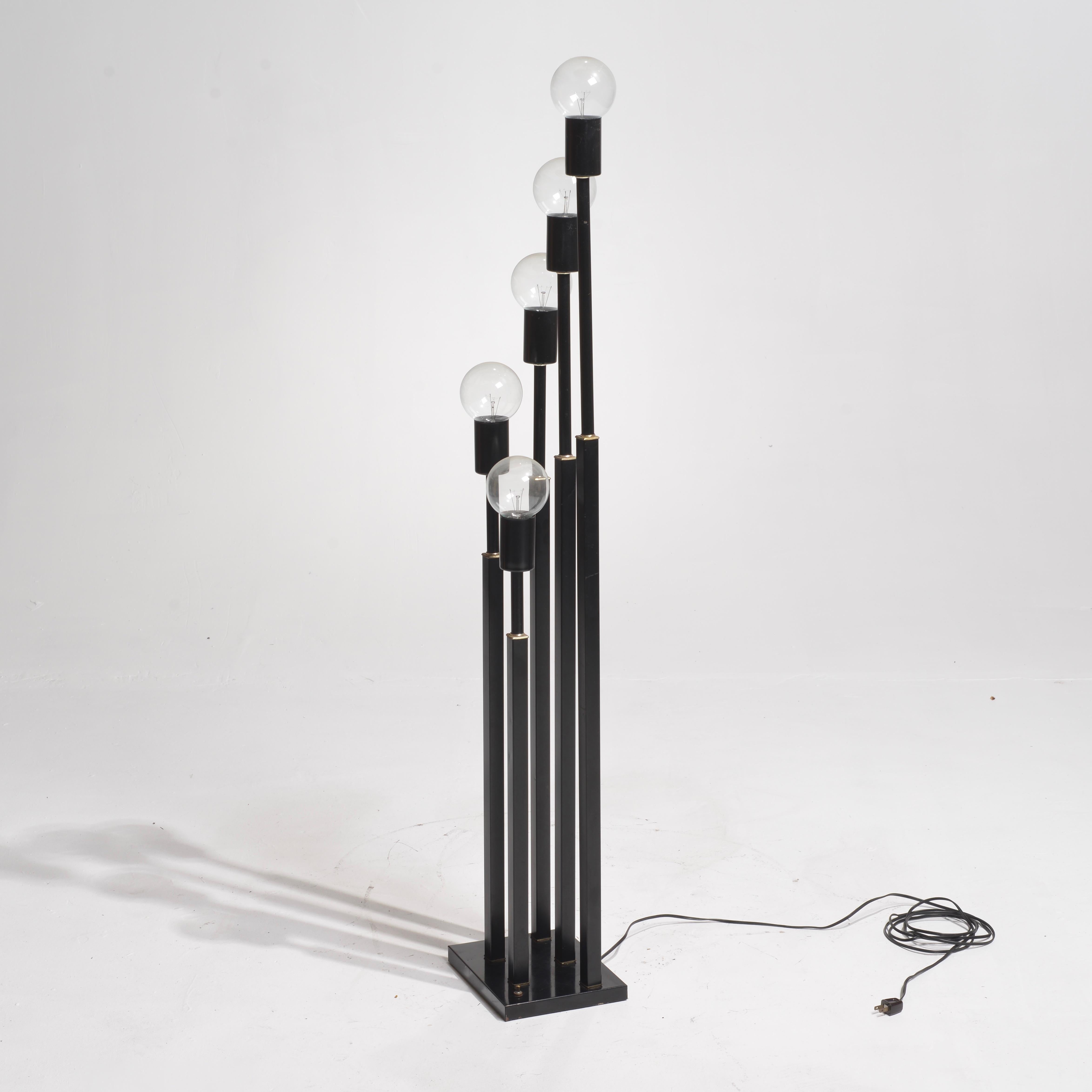 This midcentury French floor lamp features five black painted steel pillars will brass rings on a square base. Each pillar ends with a round clear bulb.