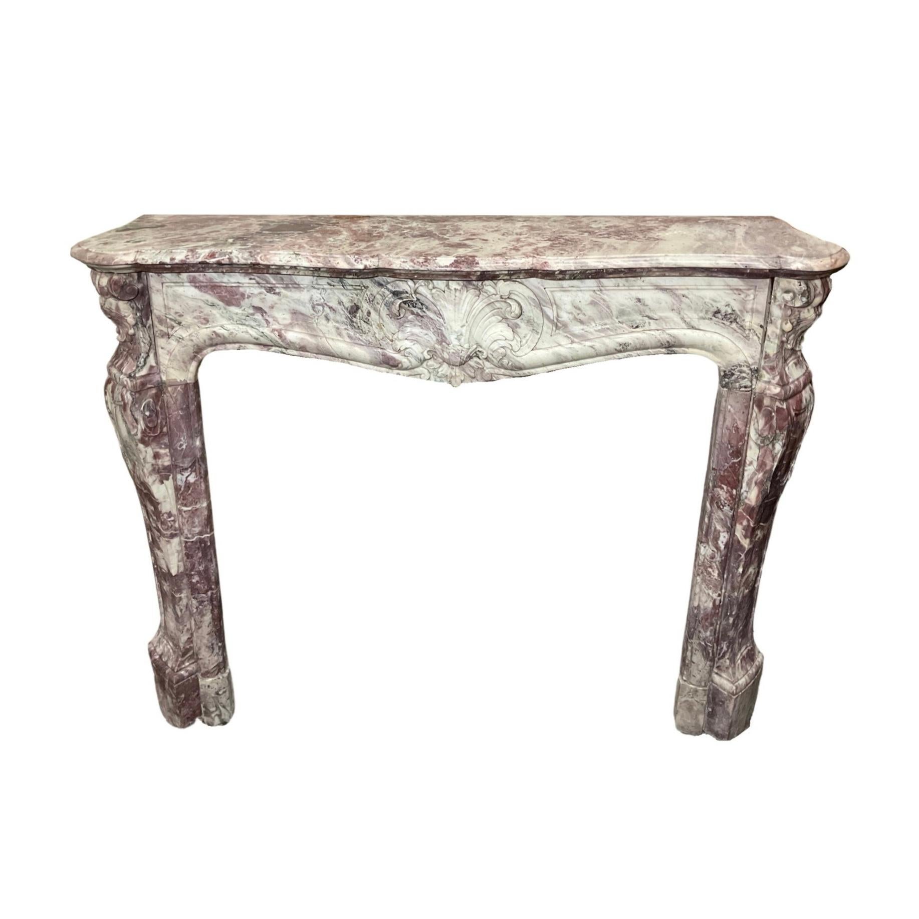 This one-of-a-kind 1850s French marble mantel is crafted from luxurious Fleur de Pêcher marble and features a Louis the 15th-inspired design. Perfect for adding timeless European elegance and refinement to any room.