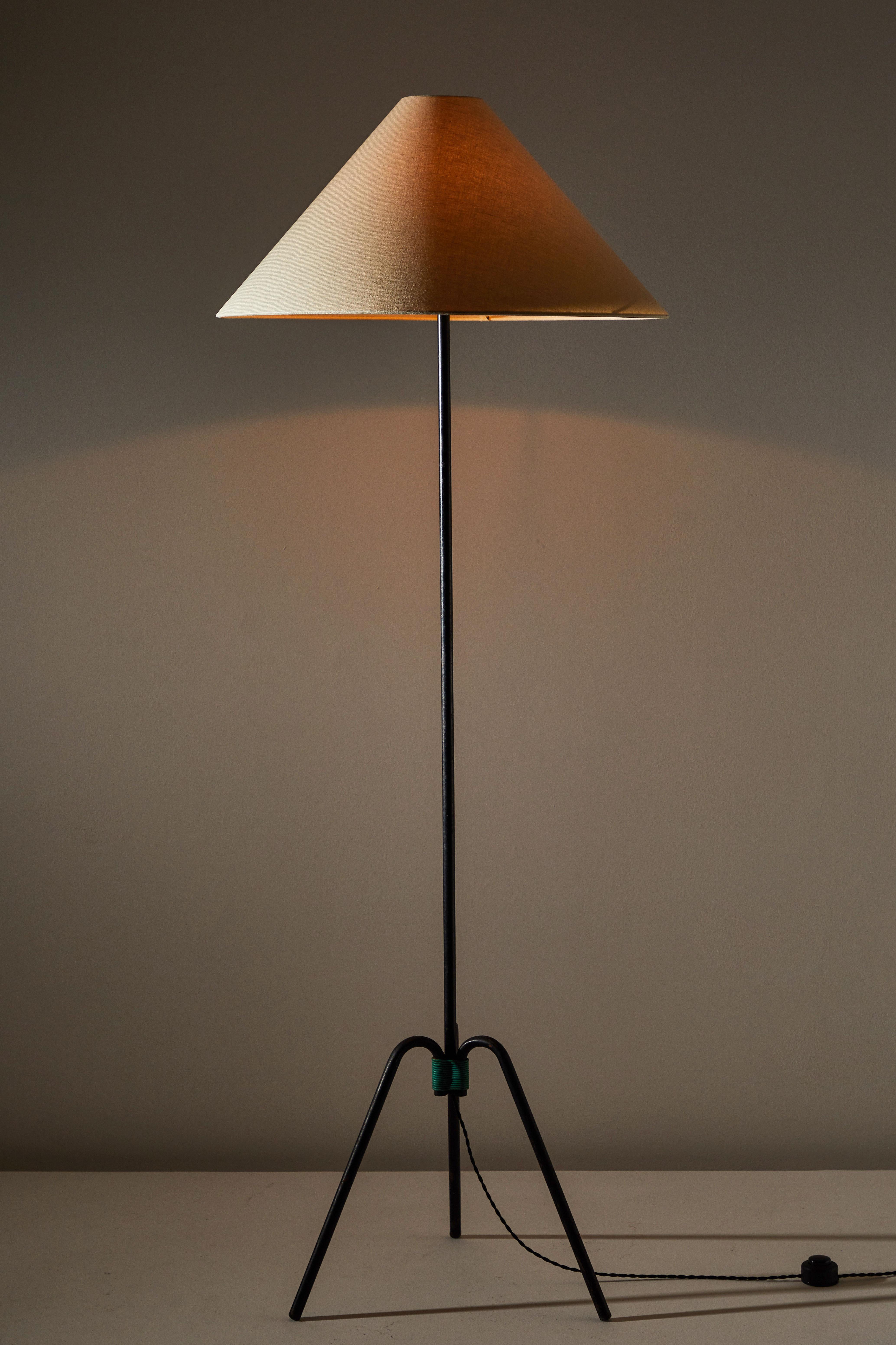 Floor lamp designed and manufactured in France, circa 1950s. Iron base, custom linen shade. Rewired with French twist cord. Takes one E27 75w maximum bulb.