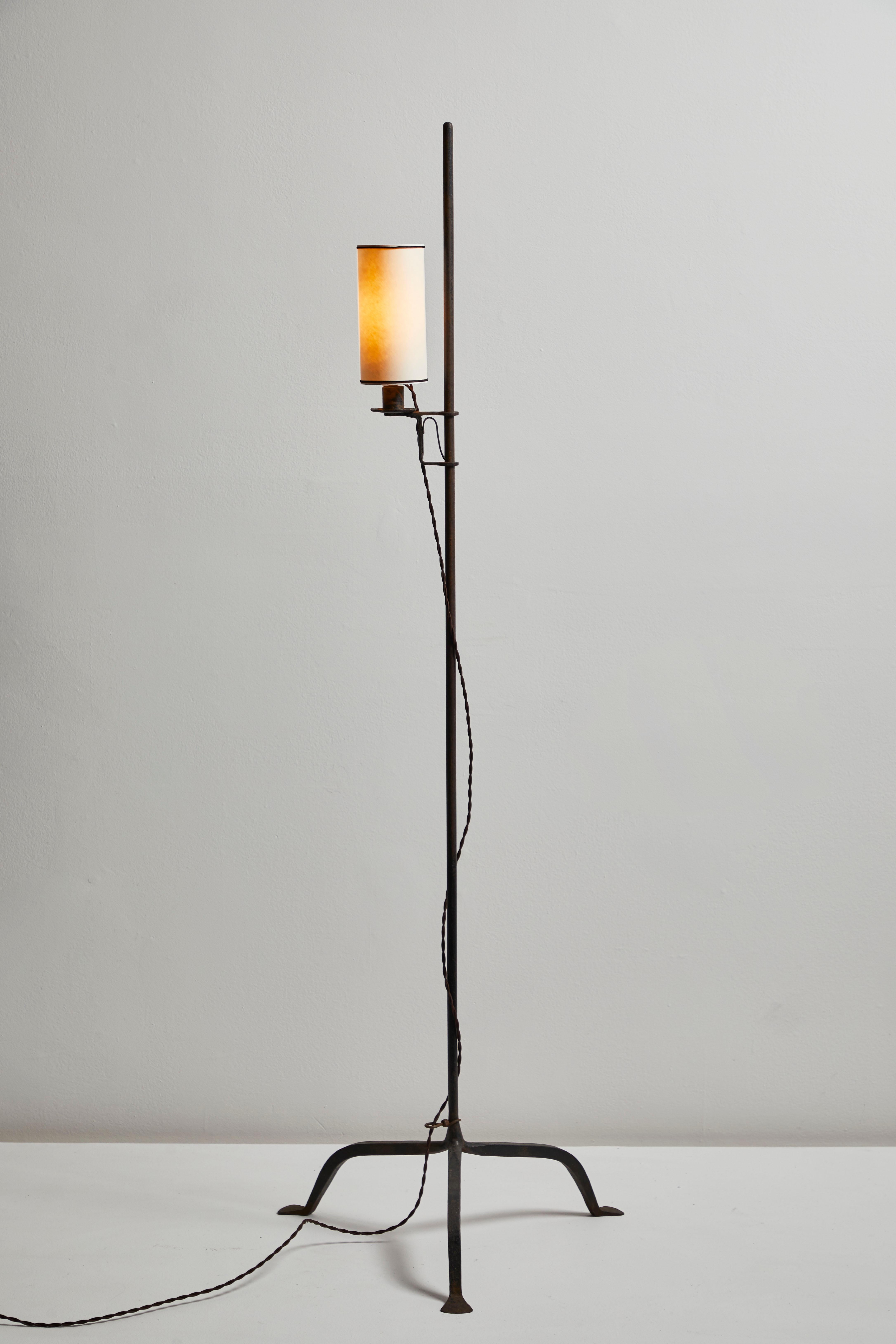 Floor Lamp manufactured in France circa 1930s. Iron base, custom parchment shade. Rewired with original French twist silk cord with original European plug. Adjustable height. Made by the metalsmith that worked on Jean Prouve productions. Takes one