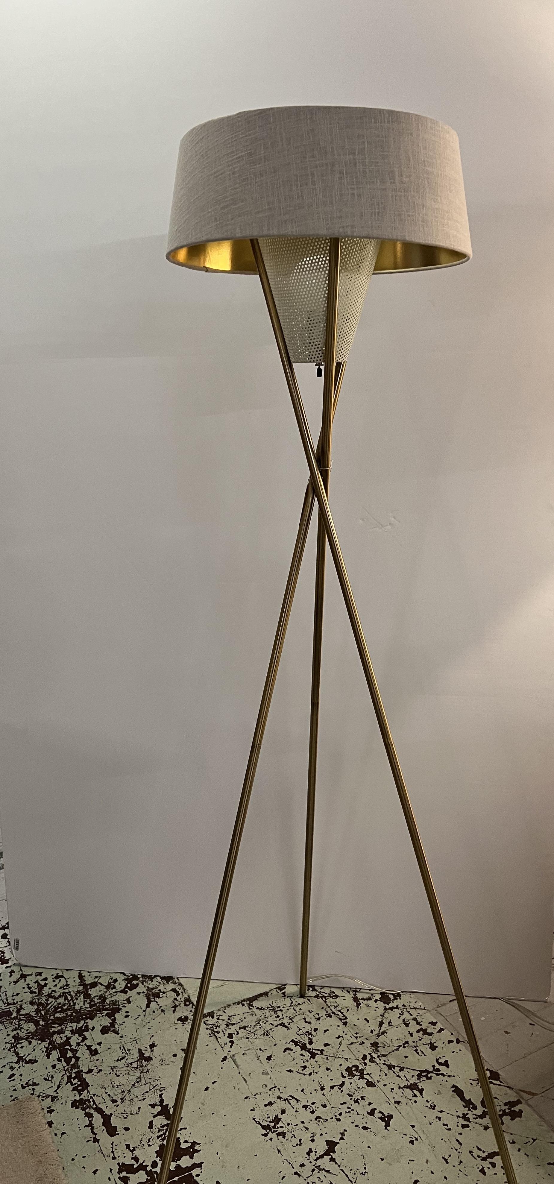 French 1950s floor lamp with three long crossed spear-like rods and a perforated metal light cover.
The shade has been redone in off-white fabric with gold paper inside matching the base.