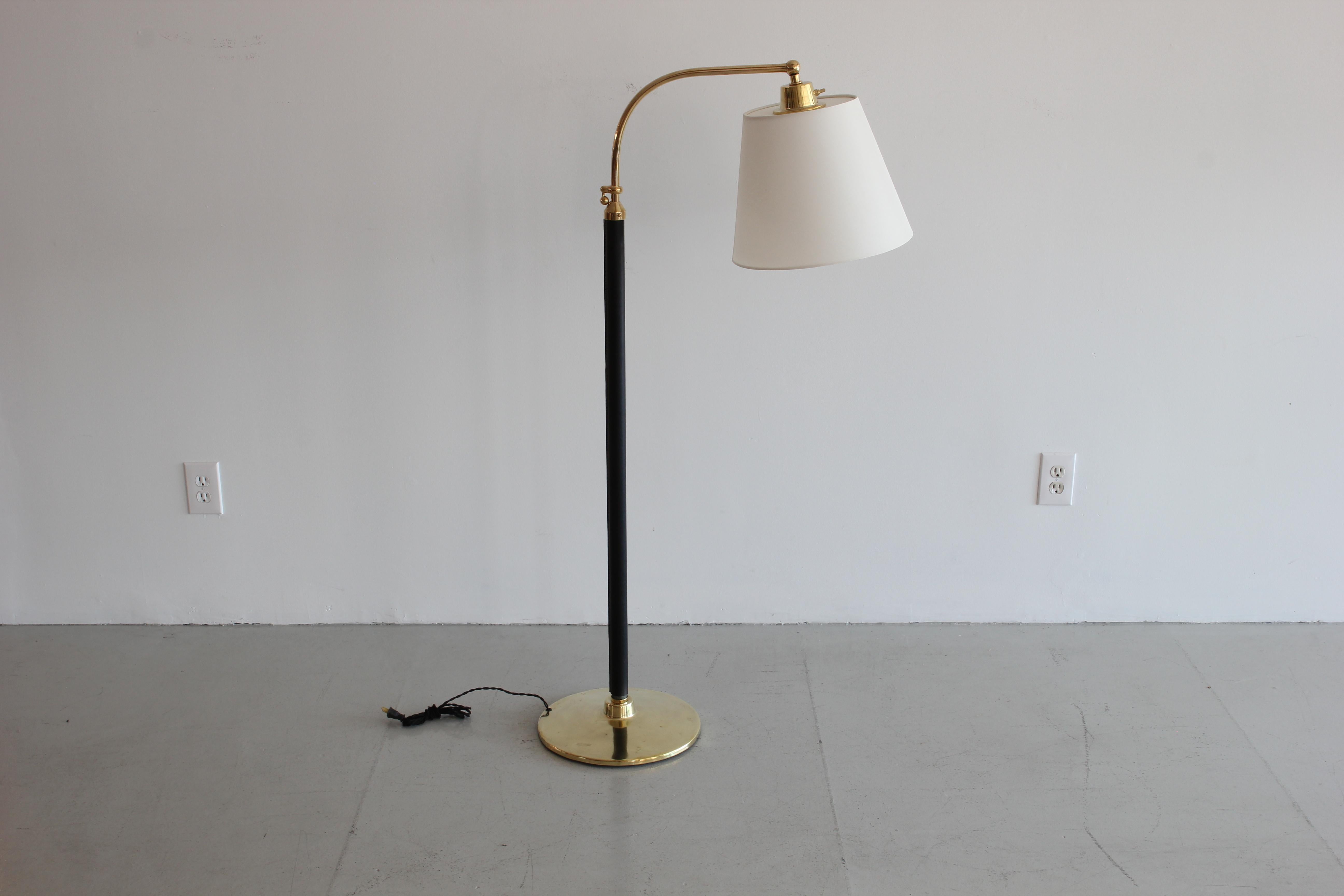 Fantastic French floor lamp with hand-stitched black leather, brass disc base and new silk shade. 

Measures: Height telescopes from 48