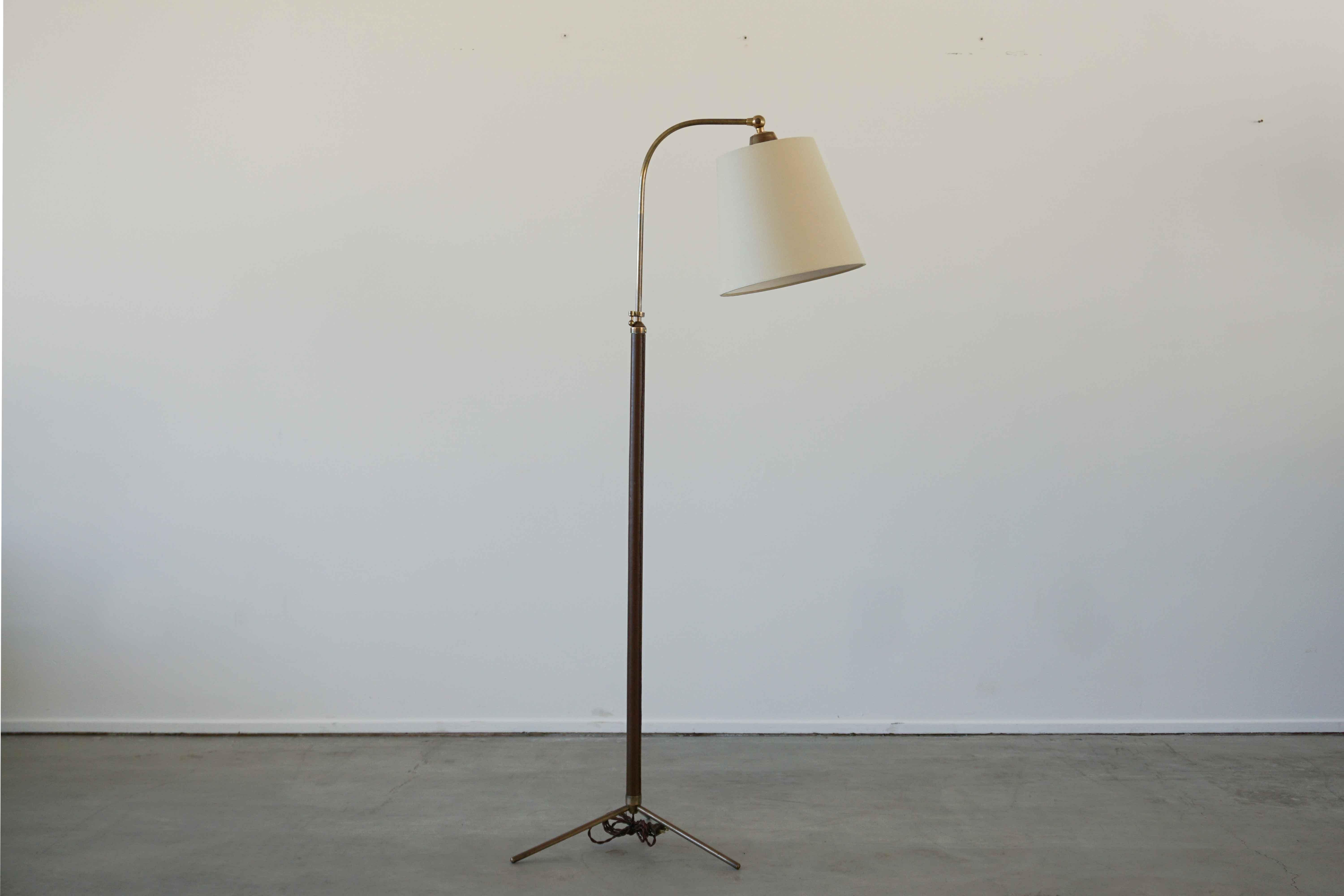 Fantastic French floor lamp with hand-stitched rich dark brown leather, contrast stitching, brass tripod base and new silk shade. Newly rewired. 

Height extends from 48” - 64.5”.