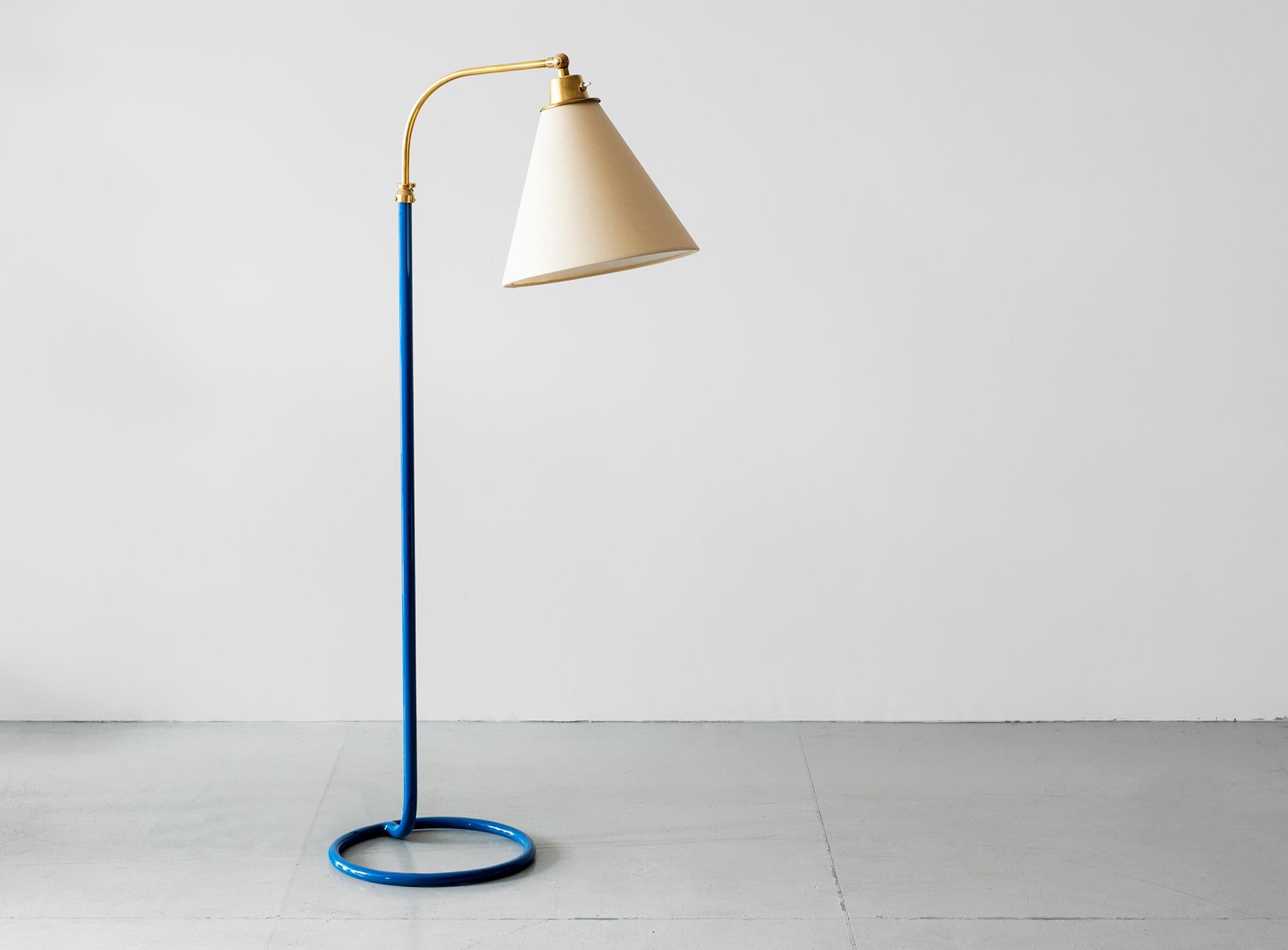 French floor lamp with lacquered blue stem, pivoting brass neck and unique circle base.
Adjustable height.
Newly rewired with new silk shade.