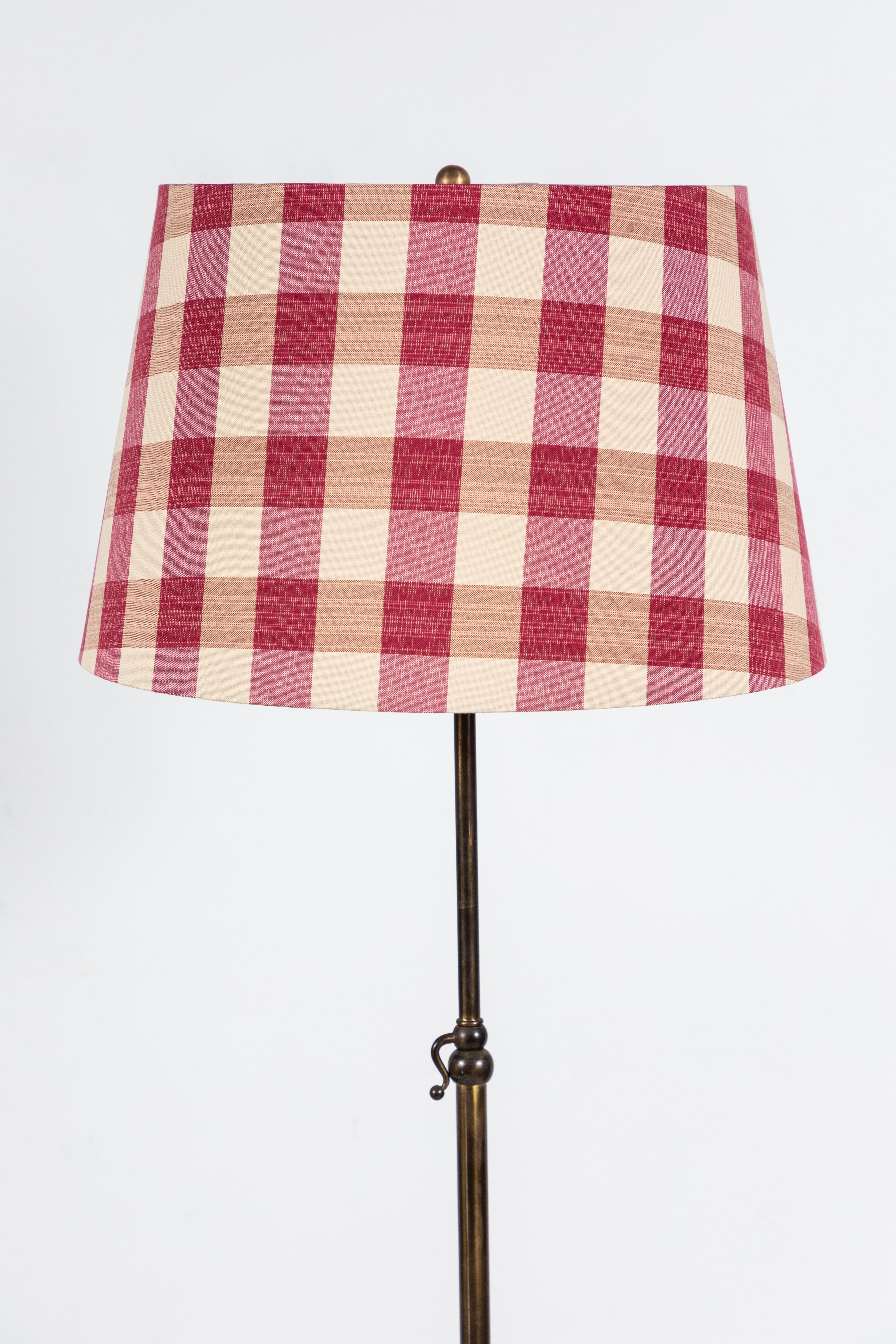 Simple and elegant French brass floor lamp with custom red and white gingham shade.