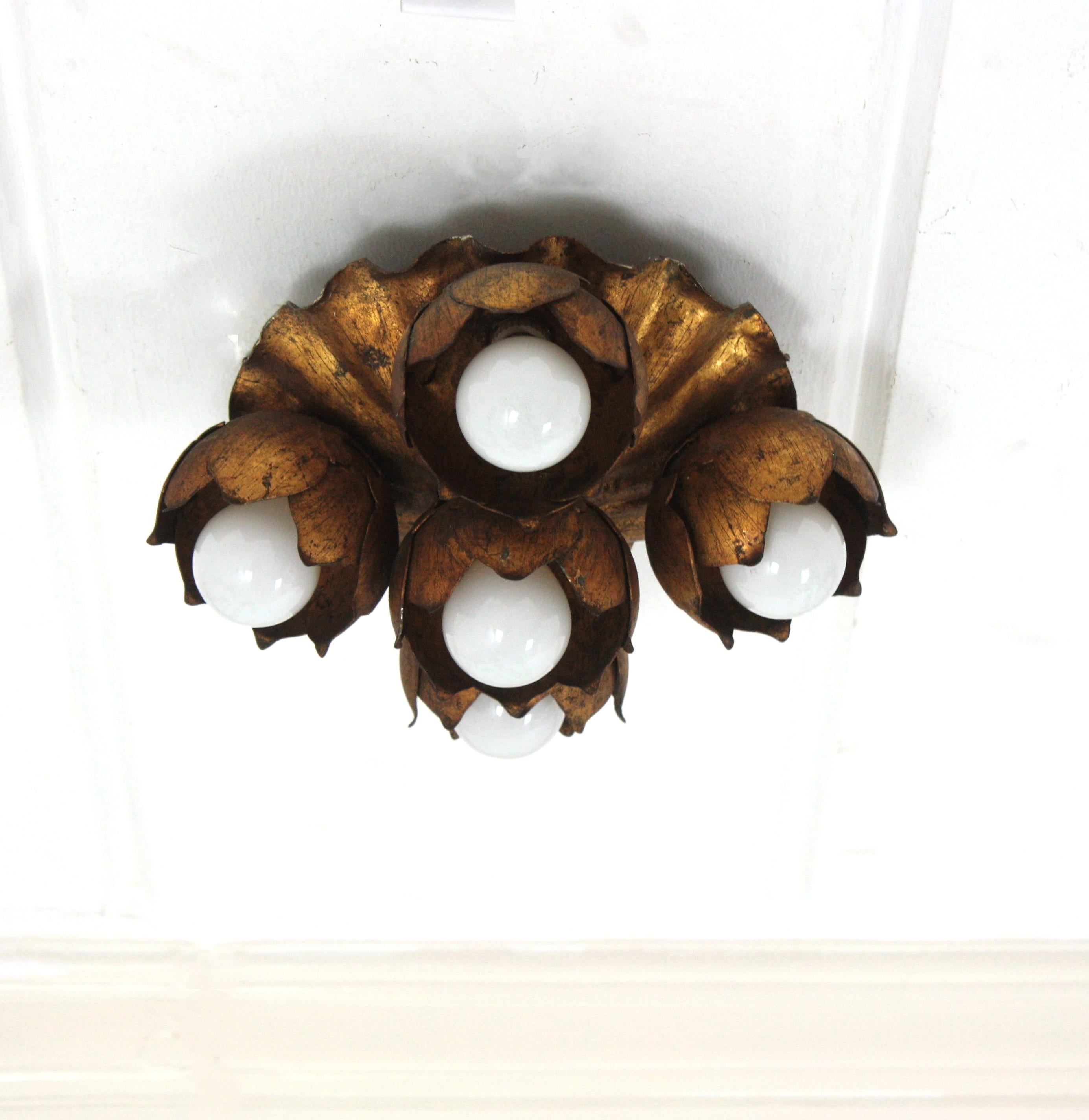 Flower bouquet ceiling light fixture / wall ligh in gilt iron

French 1940s gilt metal five light Floral Bouquet wall or ceiling light fixture. 
A beautiful Hollywood Regency gilt wrought iron floral flush mount or wall sconce. This lovely light