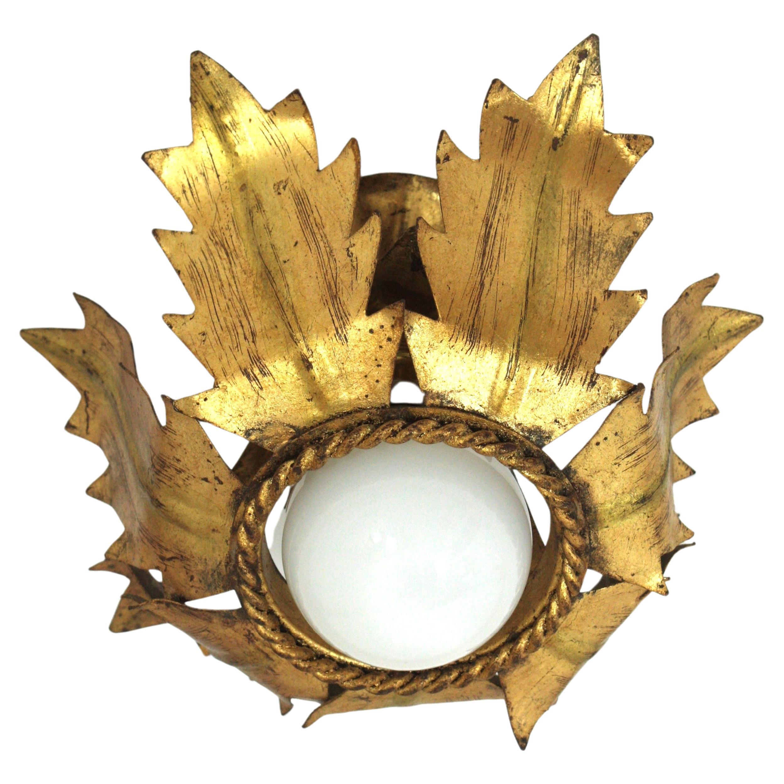 Eye-catching single flower bud/ tole flush mount light fixture in gold leaf gilt iron. France, 1940s.
This handwrought iron ceiling light fixture has a terrific aged patina showing its original gold leaf gilding.
It can be used as a flush mount, as