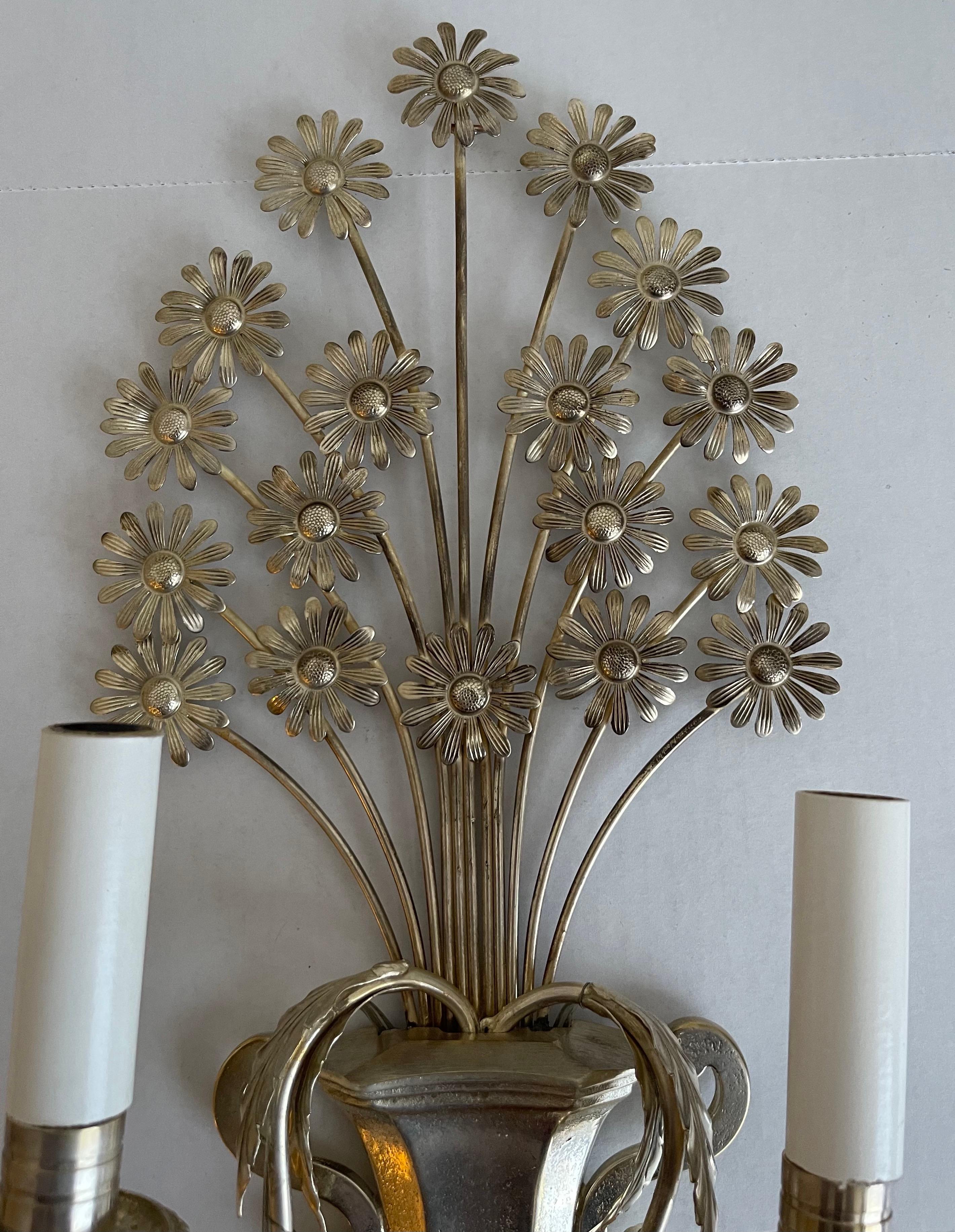 1950s French metal flower sconce. Newly silver plated and polished. Newly rewired. takes two chandelier bulbs (not included).
Please note that additional components such as back plates may be required for installation and are not included with the