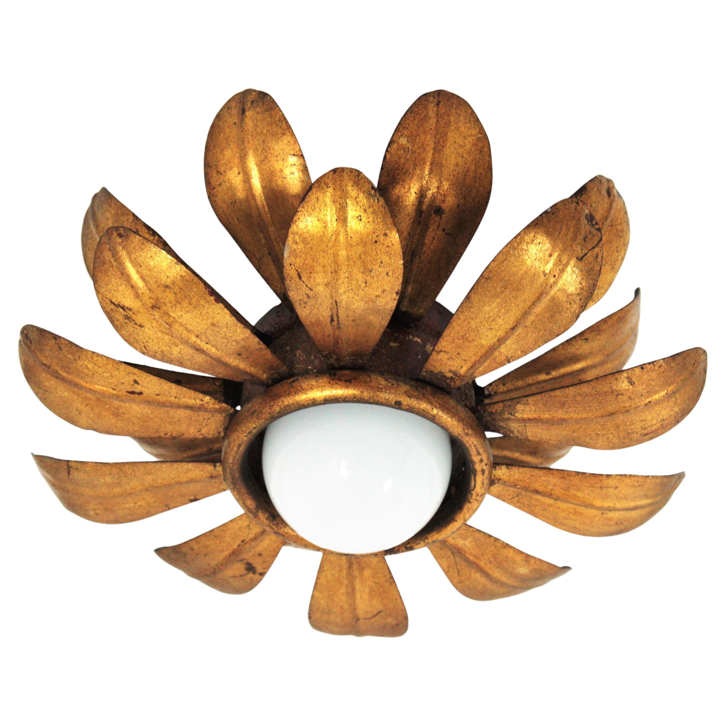 Sunburst Flower Flush Mount / Pendant, Iron, Gold Leaf, France, 1950s
Hollywood Regency double layered sunburst floral flush mount or light fixture. This ceiling sconce was finely executed, all made by hand and gilded with gold leaf.
It has a