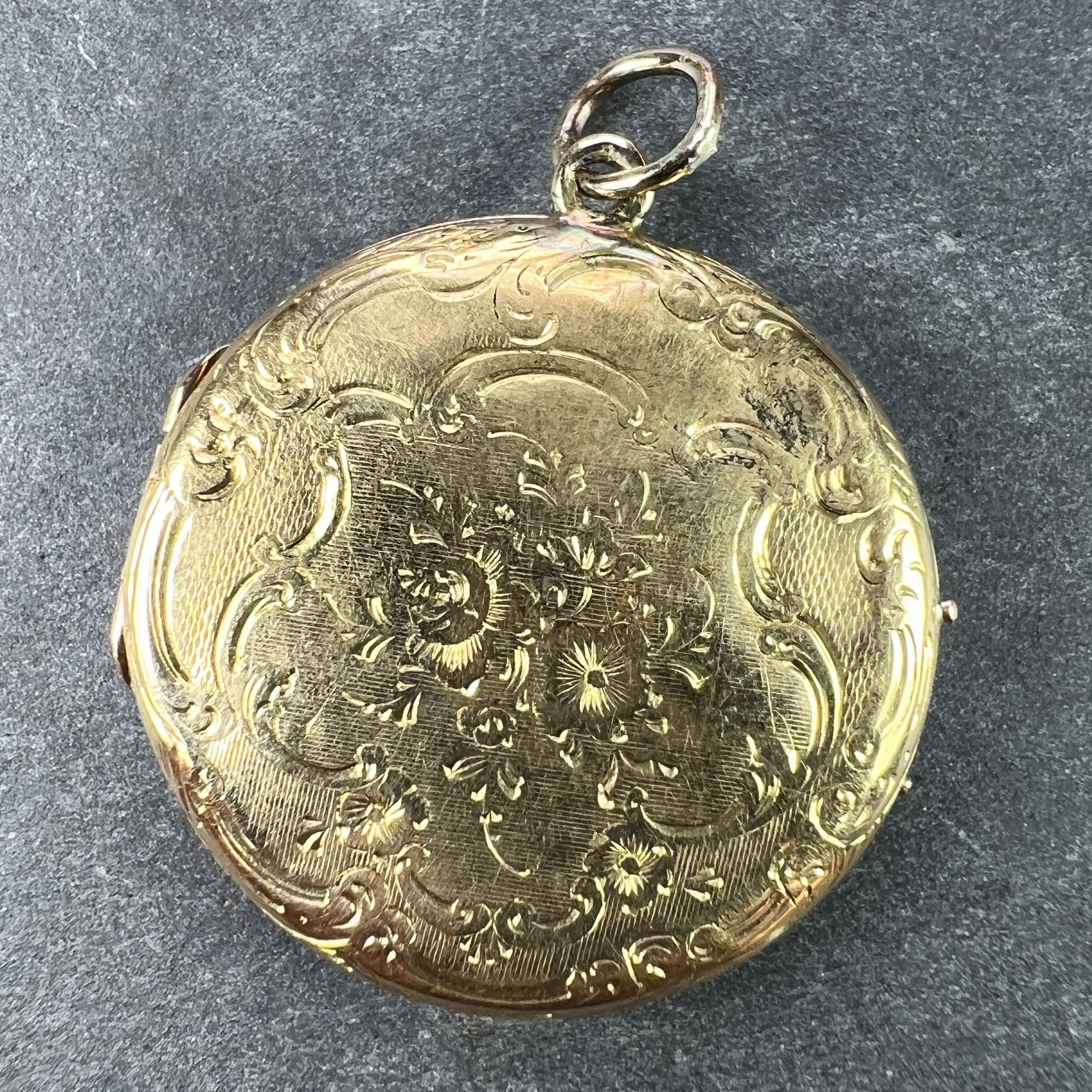 A French 18 karat (18K) yellow gold pendant locket with an engraved spray of flowers to the centre of each side with an engraved scrolling surround. Stamped with the eagle mark for 18 karat gold and French manufacture.
Some dents but otherwise good