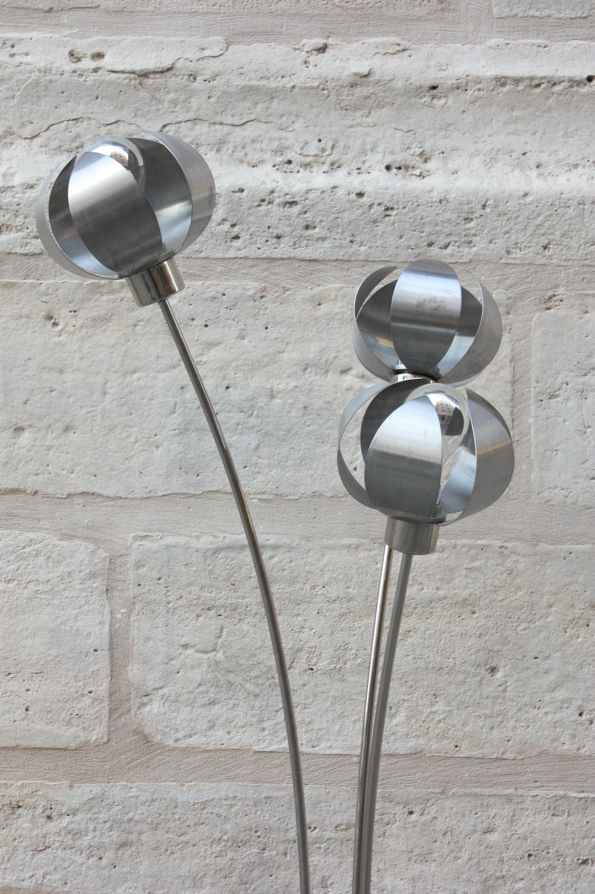 French
Floor lamp, circa 1970
silvered and brushed steel, the three shades decorated with flower petals, the three attached stems on a circular base
Measures: 57 3/4 in. (147 cm.) high ; 9 3/4 in. (25 cm.) diameter.
     