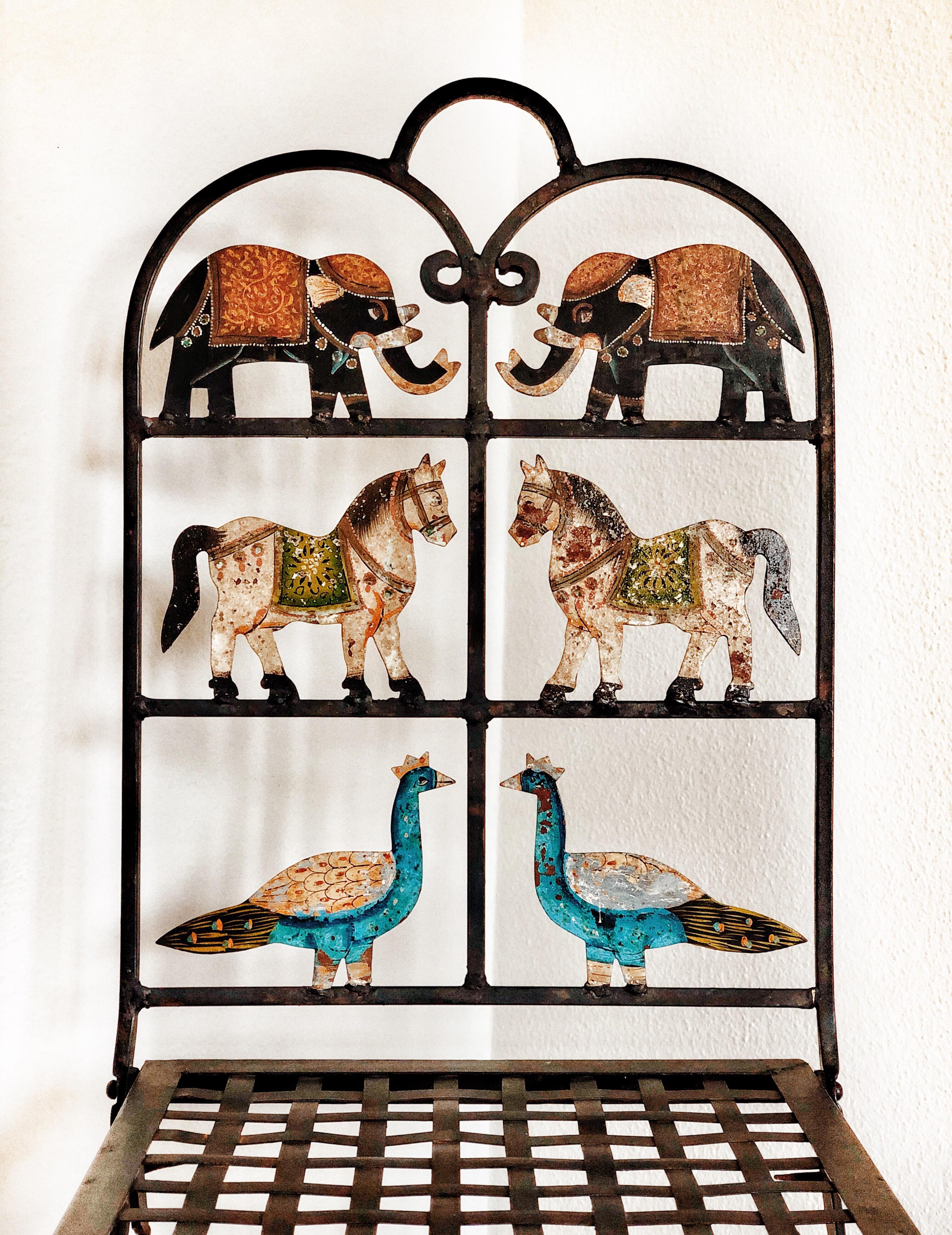 Complimentary Shipping Worldwide
A whimsical pair of wrought iron folding garden chairs with painted animal cutouts, including elephants, horses and peacocks. These chairs are utterly charming, the weathering of the surface only adding to their