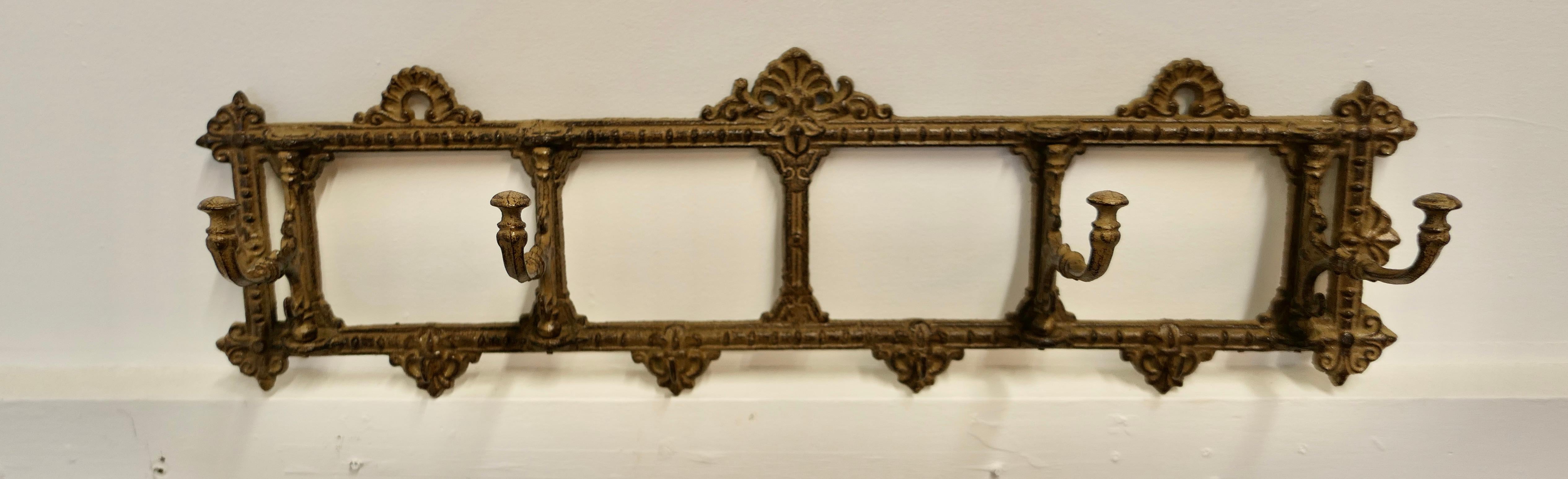 French Folding Coat Hook Rack  

A very unusual set, the wall rack has 4 complete fold flat hooks set on an iron frame, the rack has an Old Dark Gilt Finish and the coat hooks swivel independently of each other from flat to any angle 
The rack is a