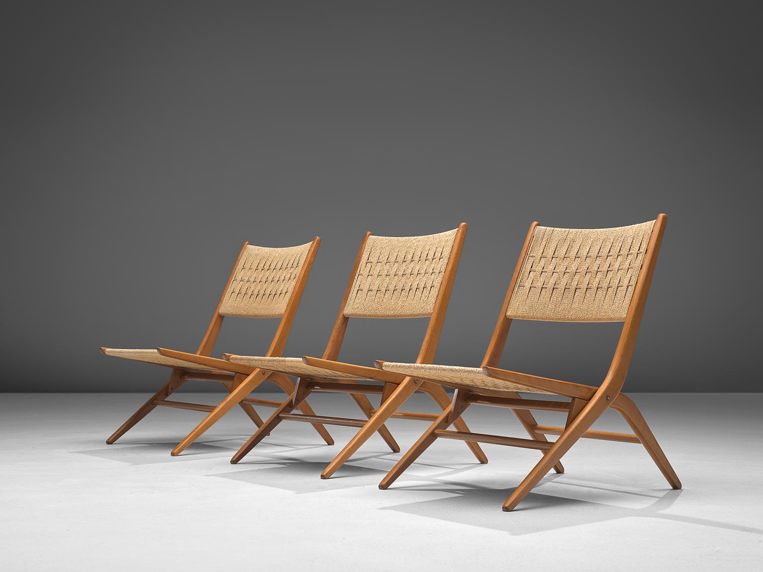 Folding slipper chairs, rope and beech, France, 1960s

Elegant French folding chairs made of beech and rope. The woven wicker shows beautiful graphical details. The beech wooden frame is designed with high attention to detail as seen in the
