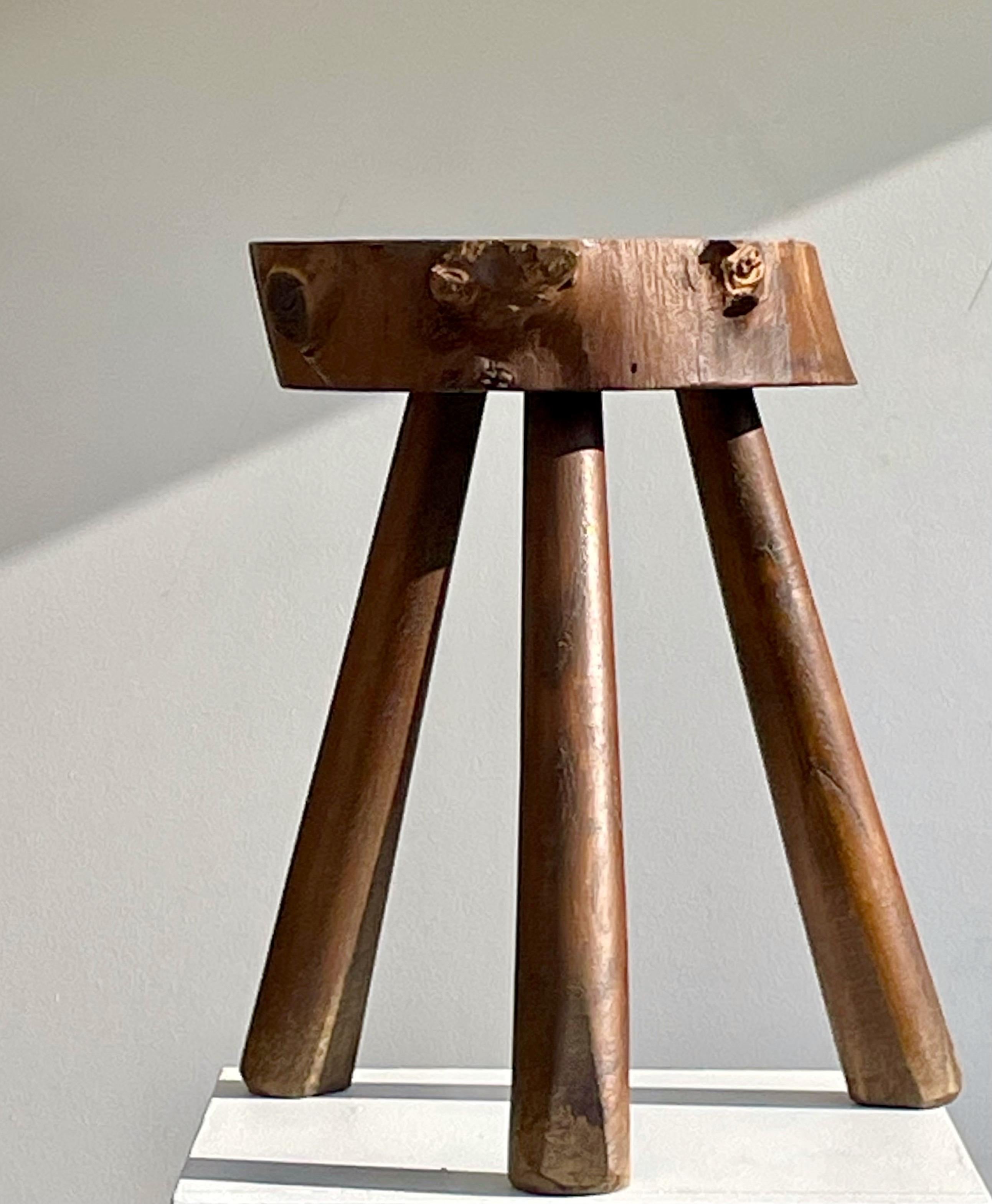 Probably a piece of French folk art, this solid wood tripod stool was likely crafted as a traditional shepherd’s seat.
The thick, hand-carved seat rests on three tapered legs, combining rustic craftsmanship with a striking brutalist presence. The