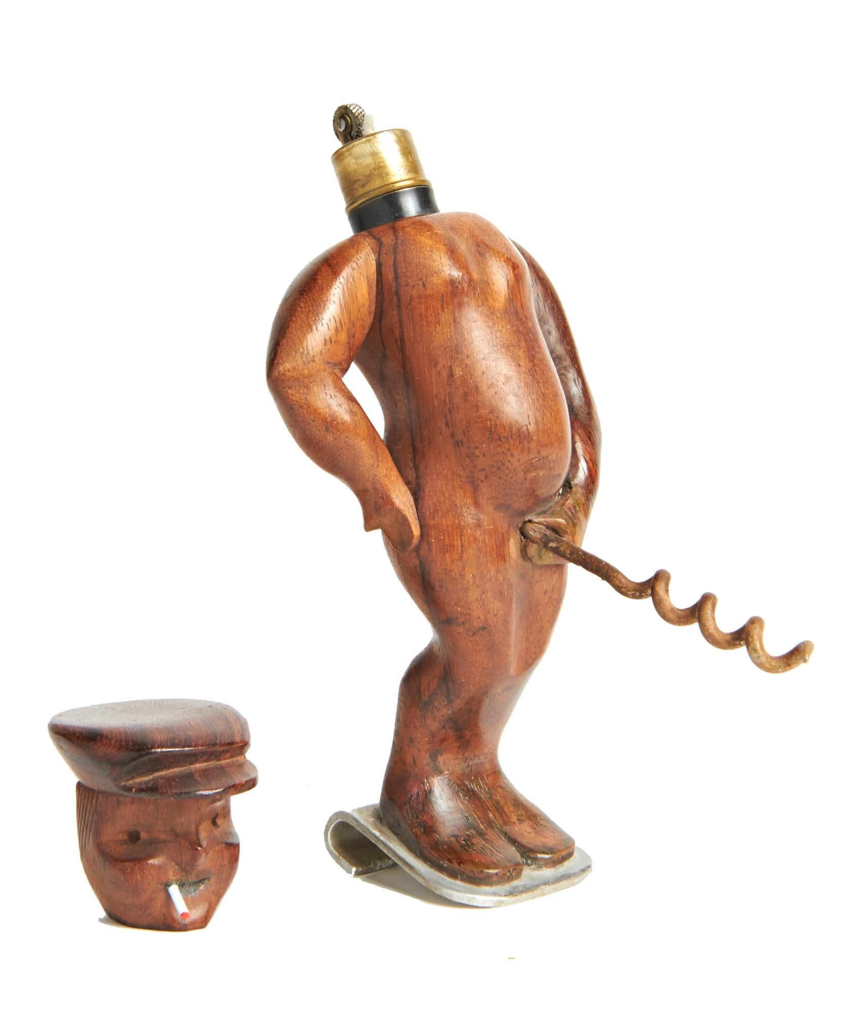 This delightfully naughty French combination aluminum bottle-opener, steel corkscrew and brass wheel and flint table lighter is hand carved from the beautifully grained wood of a grapevine. The figure stands on an aluminum curved bottle-opener base,