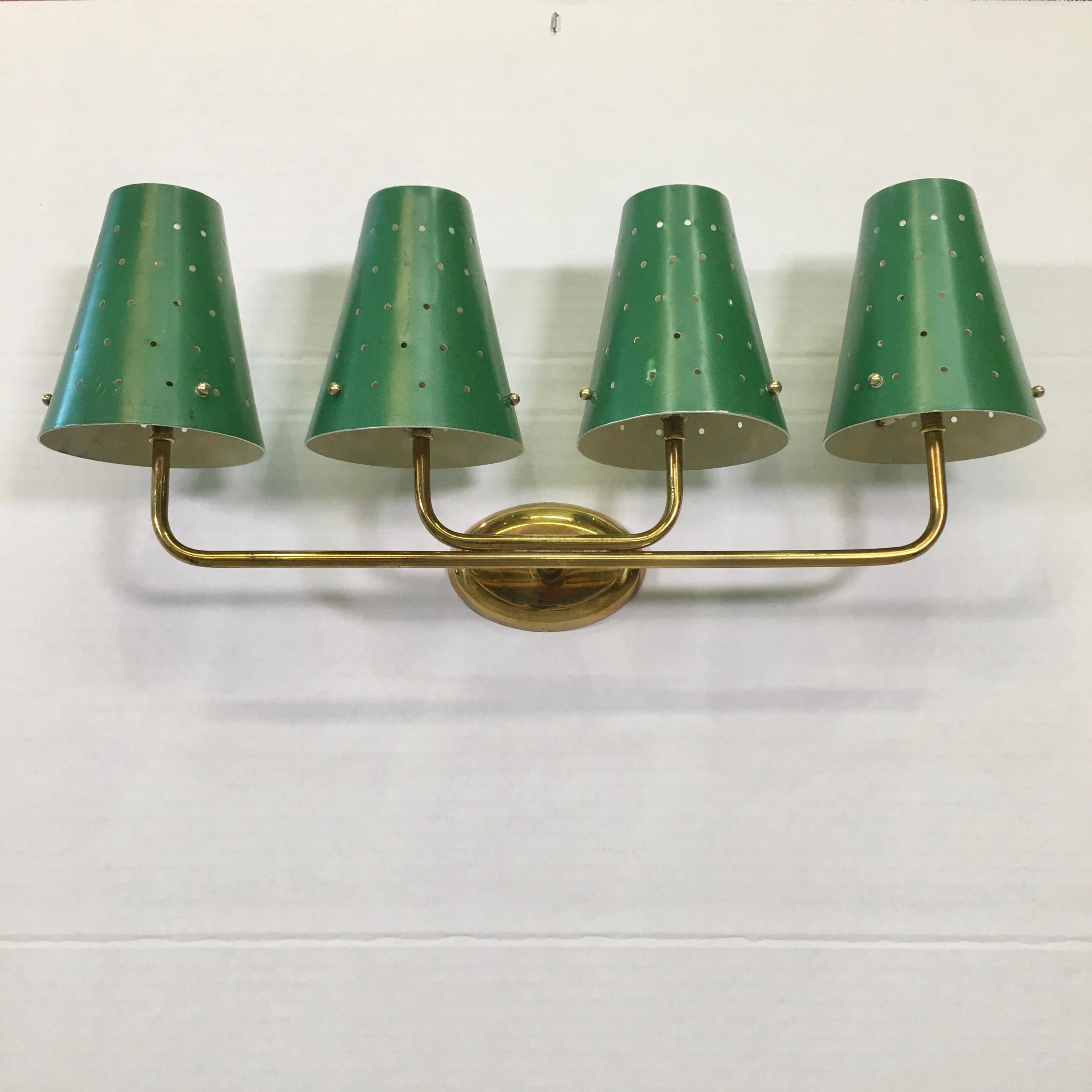 Fantastic vintage 1950s French wall light with four lateral brass arms mounted to an oval backplate. Four perforated aluminum tapered cone shades in green enamel mounted with brass screw pins to the candelabra sockets. Alas we have only this one.