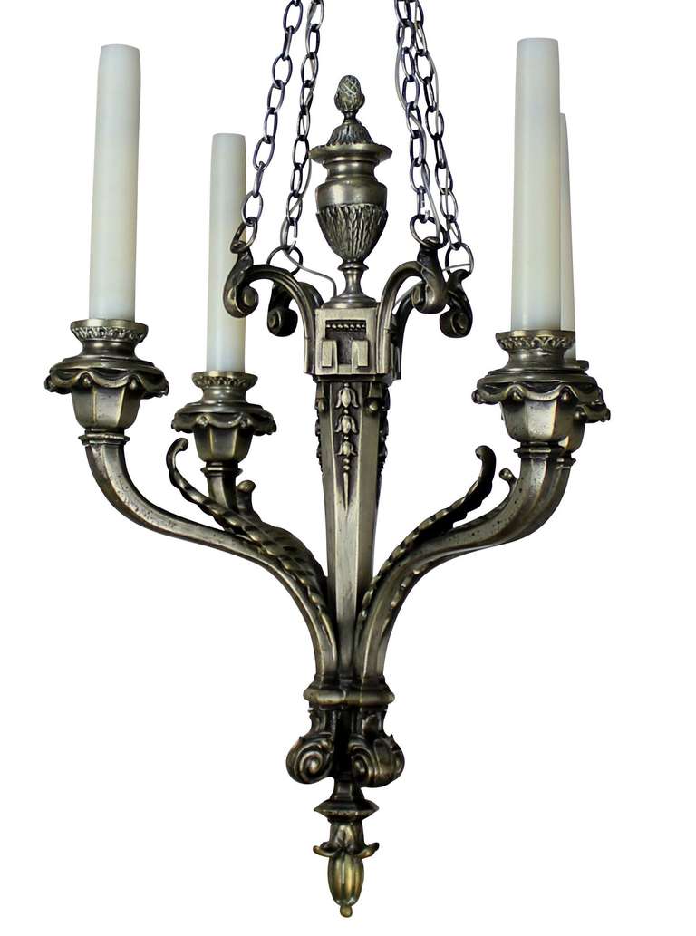 A French silver plated bronze four-branch chandelier in a neoclassical style.