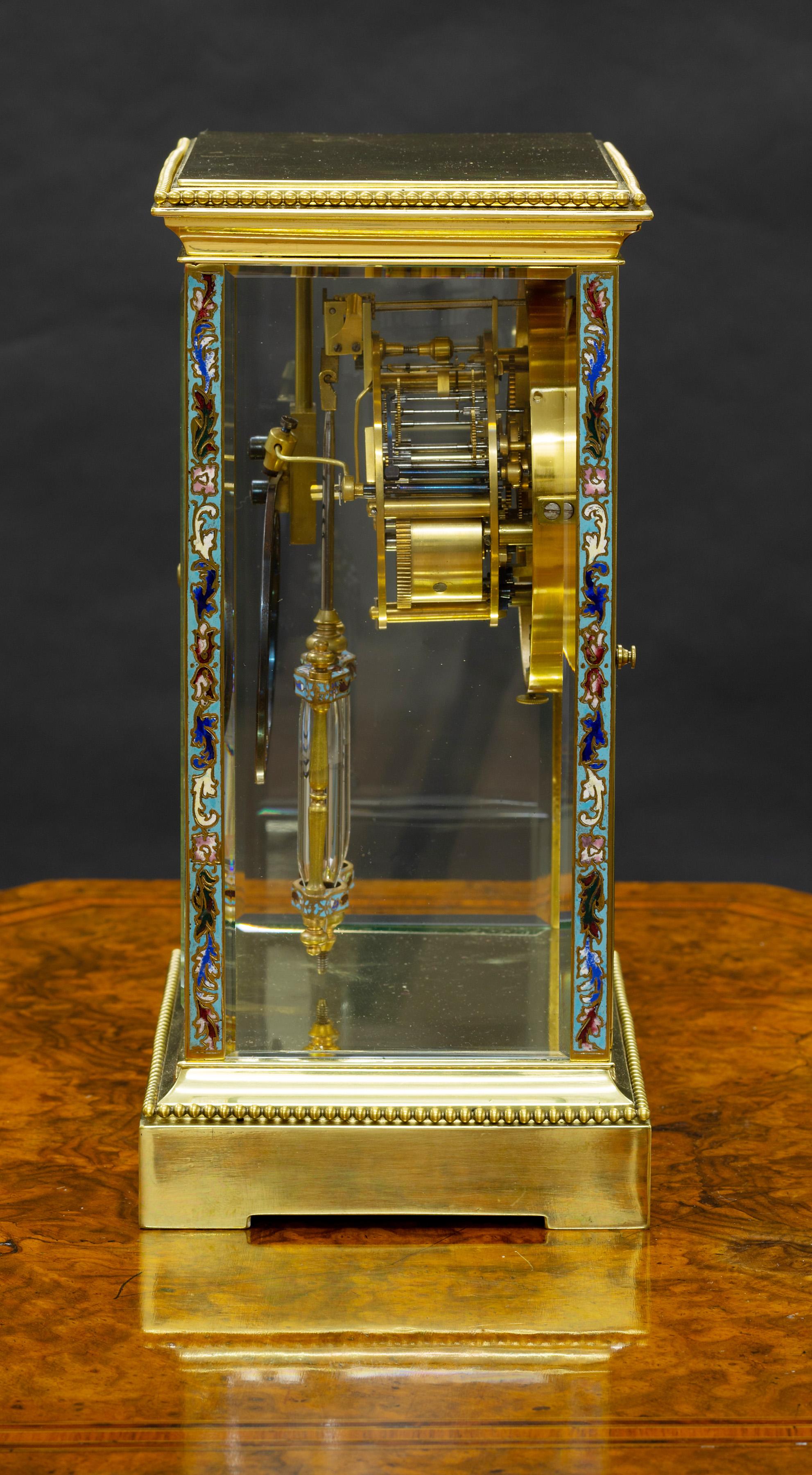 French four glass clock standing on a raised base with beaded decoration and fine Champleve enamel decoration to the pillars and bezel with further decorated mercury compensated pendulum.

Eight day movement signed 'Japy Freres 'striking the hours