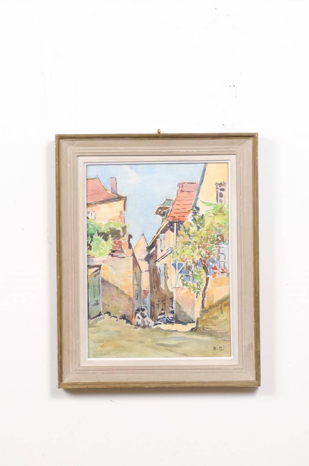 A French framed watercolor from the 19th century depicting a village scene with women in traditional costumes, signed R.G. Born during the politically dynamic 19th century, this framed watercolor features a lovely palette made of pastel tones. A