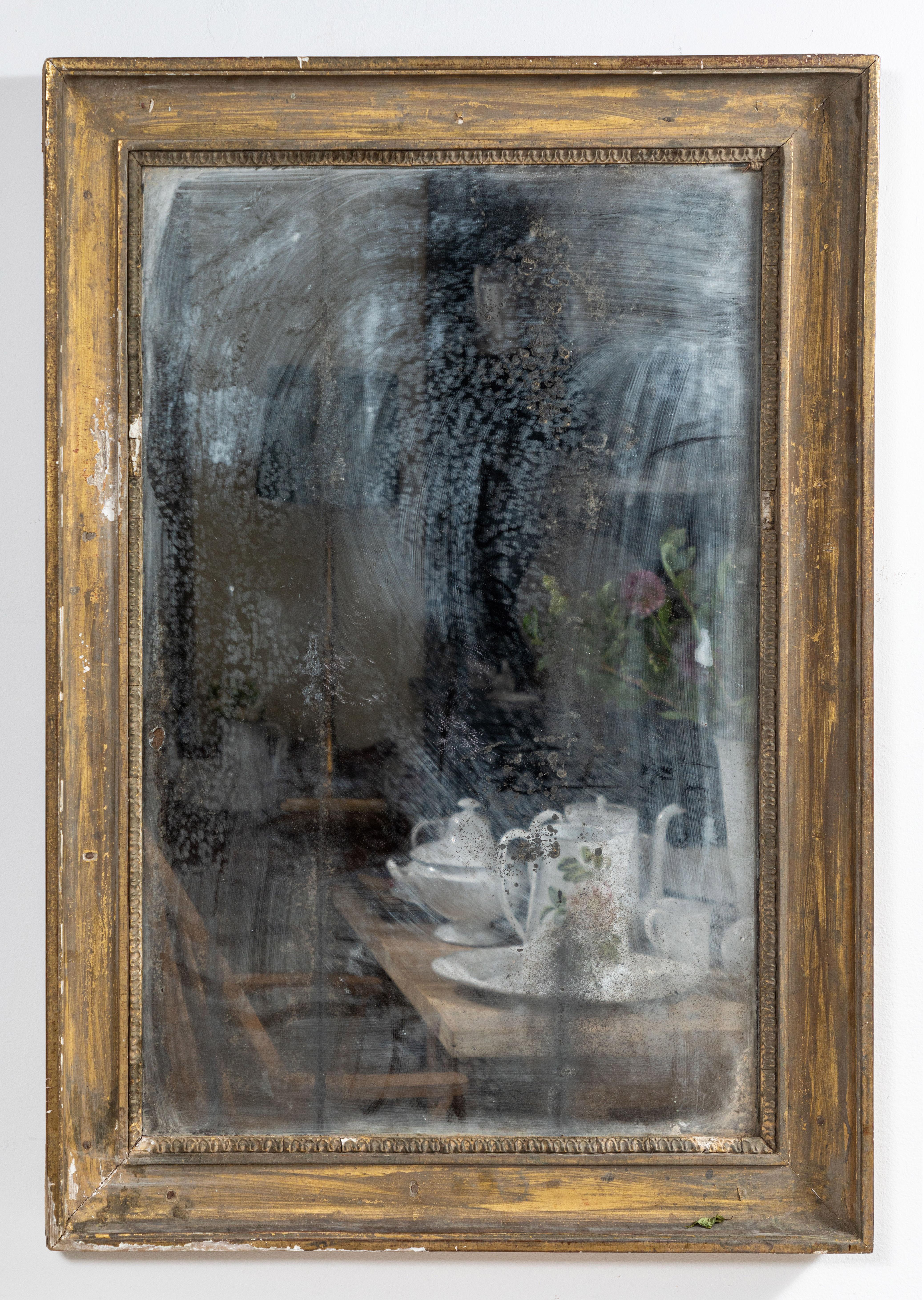 French framed mirror with beaded details. Original antique mirror adds a beautiful layer of patina.