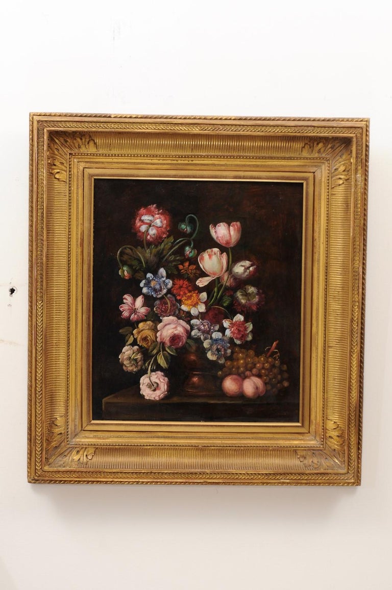 A French framed oil on canvas still life painting from the 19th century, in the style of the Dutch School. Created in France during the 19th century, this framed oil on canvas painting depicts an exquisite bouquet of colorful flowers capturing all
