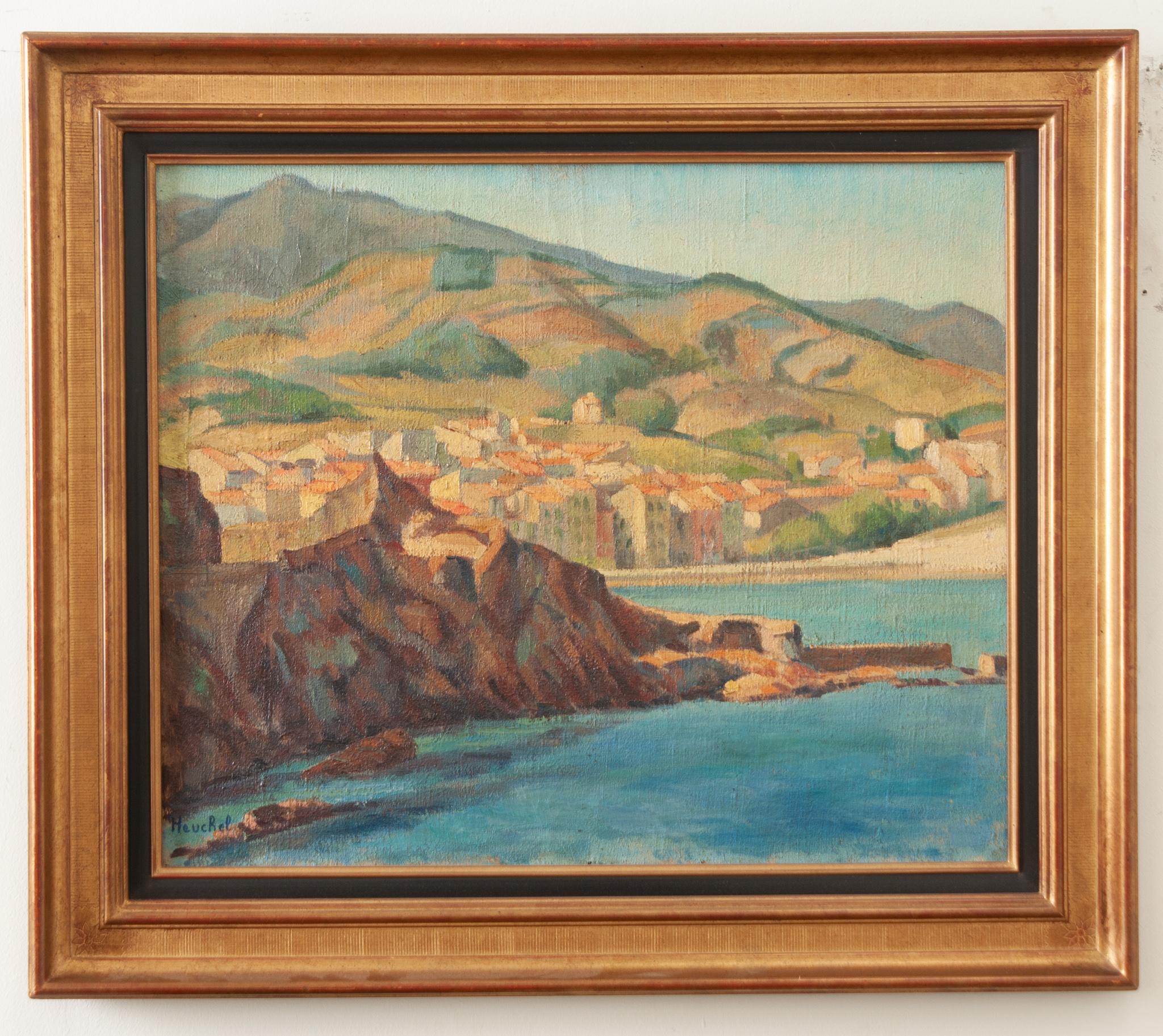 A painting on canvas depicting a coastal cityscape, signed by the artist, “Heuchel”. This painting is beautifully painted with a vibrant color palette and texture. The gold gilt frame is luminous and has an interior ebonized trim. Fixed with a wire