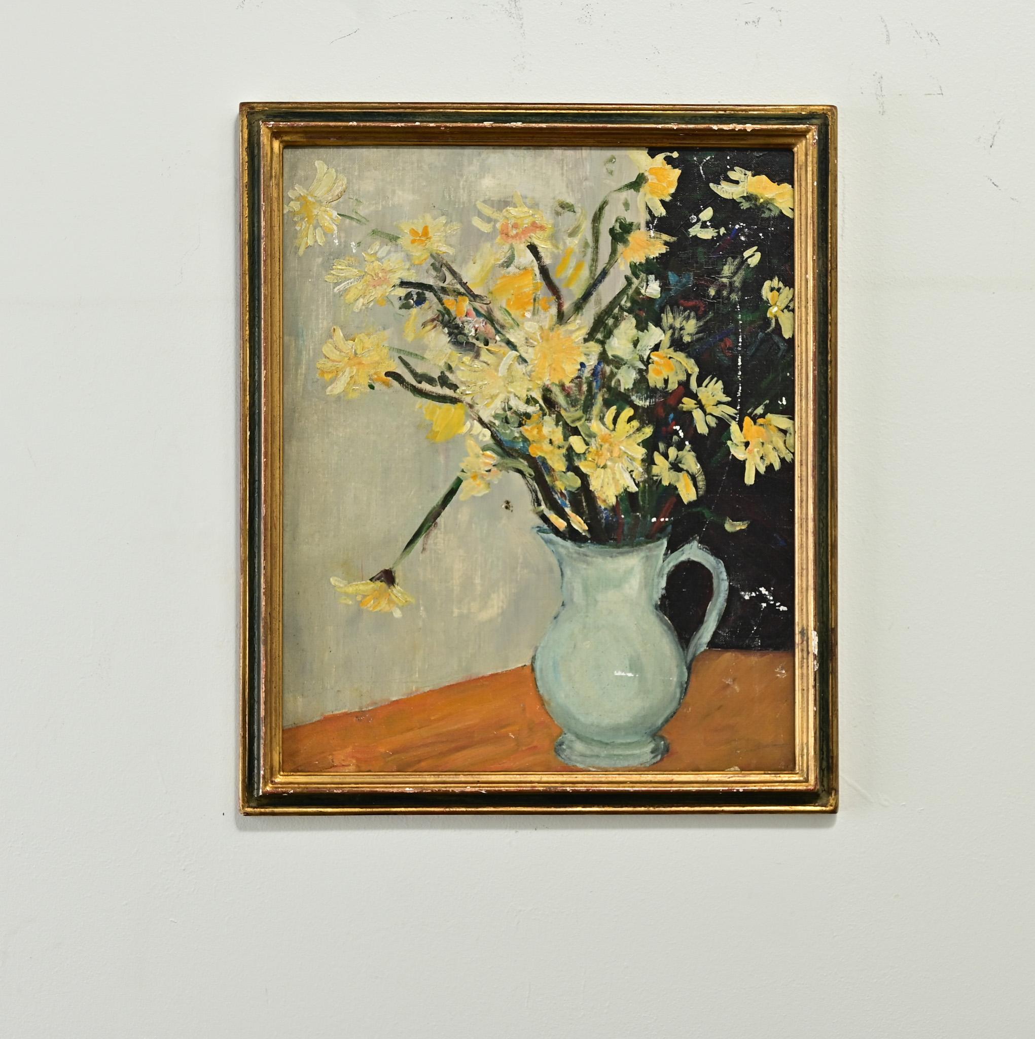 A cheerful French still life painting on board depicts a blue vase with yellow flowers and an abstract background. Surrounded by a complimentary black and gold painted frame, this little painting is perfect for your art collection. Fixed with a