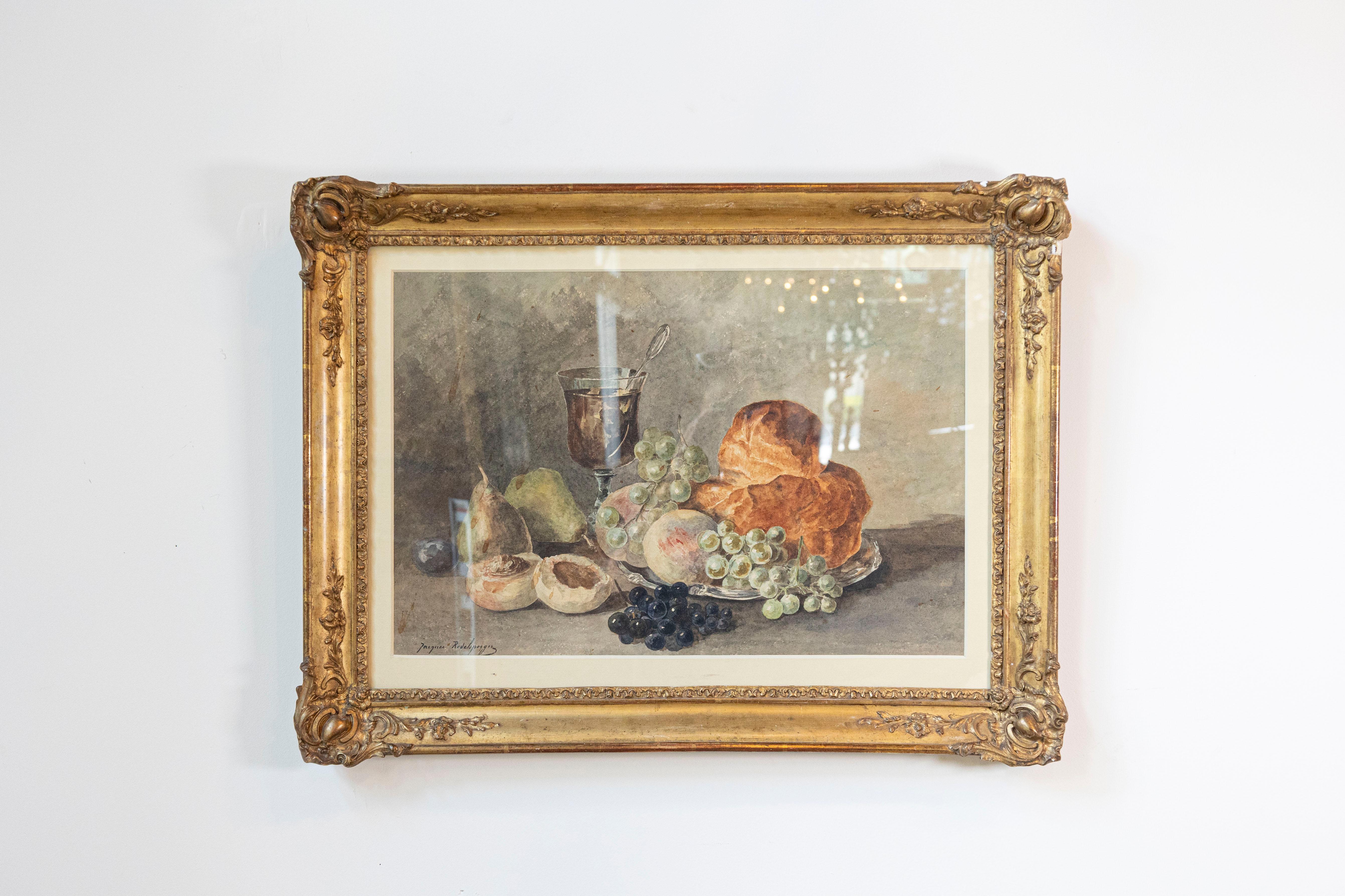 Acquerello di natura morta francese incorniciato della fine del XIX secolo, firmato Jacques Redelsperger e dedicato sul retro. Creato in Francia nell'ultimo quarto del XIX secolo, questo acquerello incorniciato raffigura frutta golosa, una brioche e
