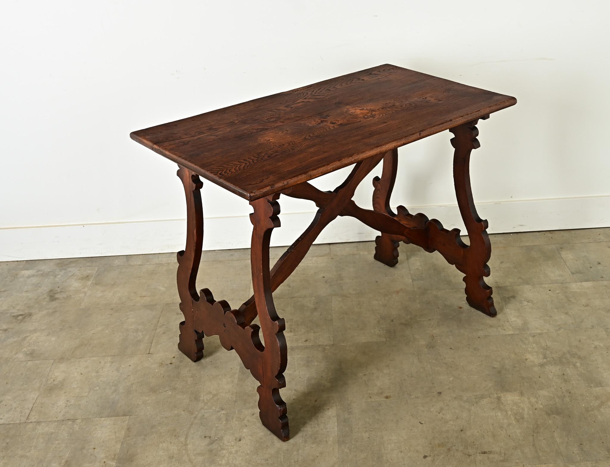 Made in France, circa 1890, this table takes inspiration from the Spanish Fratino, a style of refectory table. It features a rectangular top with exciting texture and grain pattern, patinated to a dark coffee tone. Improvised repairs in the form of