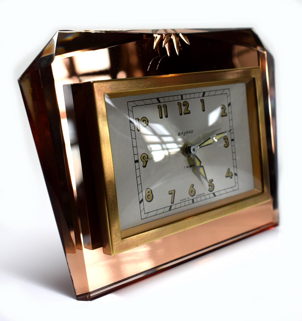 If you love glam as i do then this is the piece for you. This a 1930s Art Deco French mirror clock made by Bayard the French clock makers. The front is complete peach colored mirror with beveled edges and etched design. It's free standing on an
