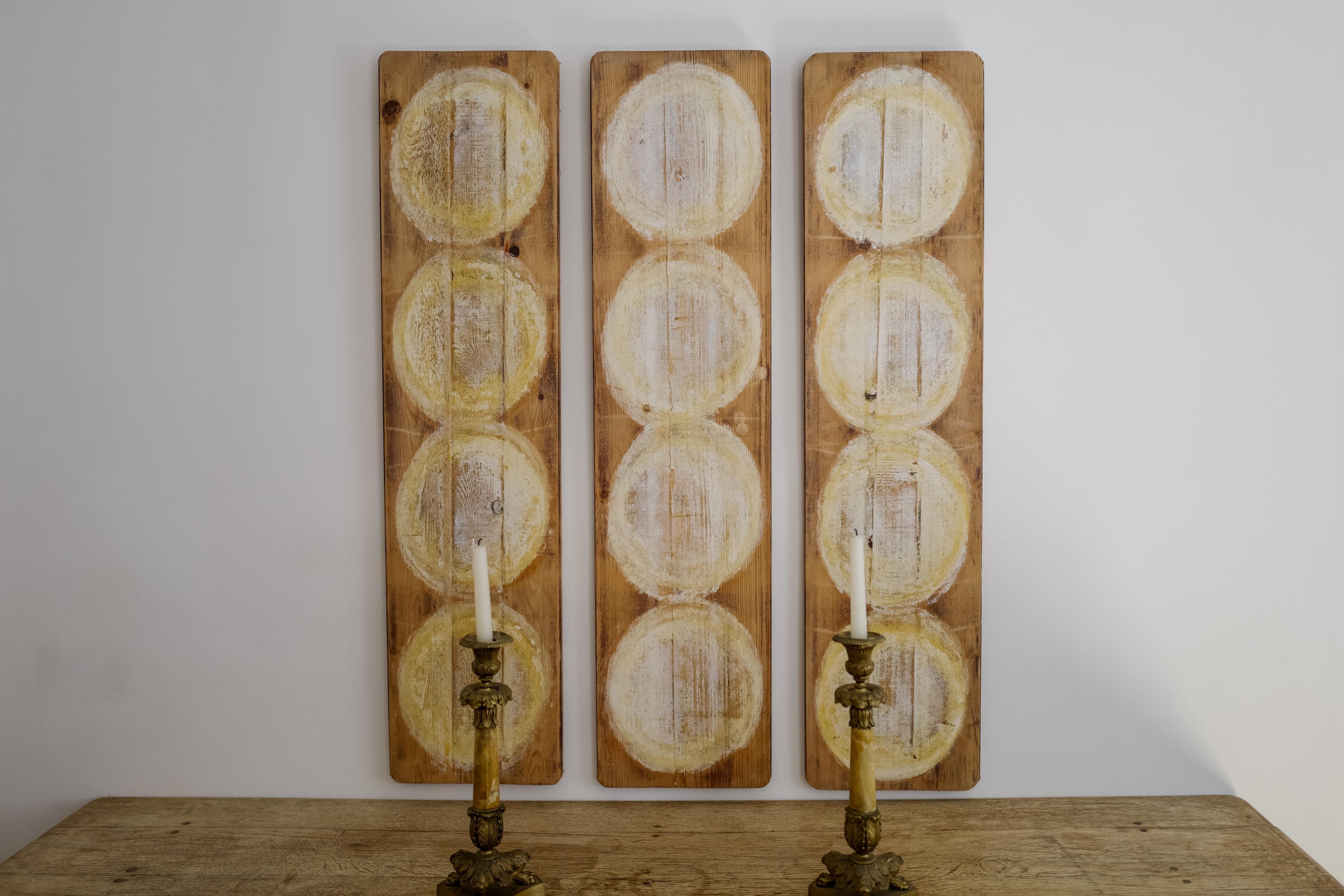 A unique conversational art piece. Originally used in France as boards to hold fromage which have been stained overtime. What is left is beautiful yellow tone circles stained into reclaimed pine wood. Both sides are stained from the cheese. This is