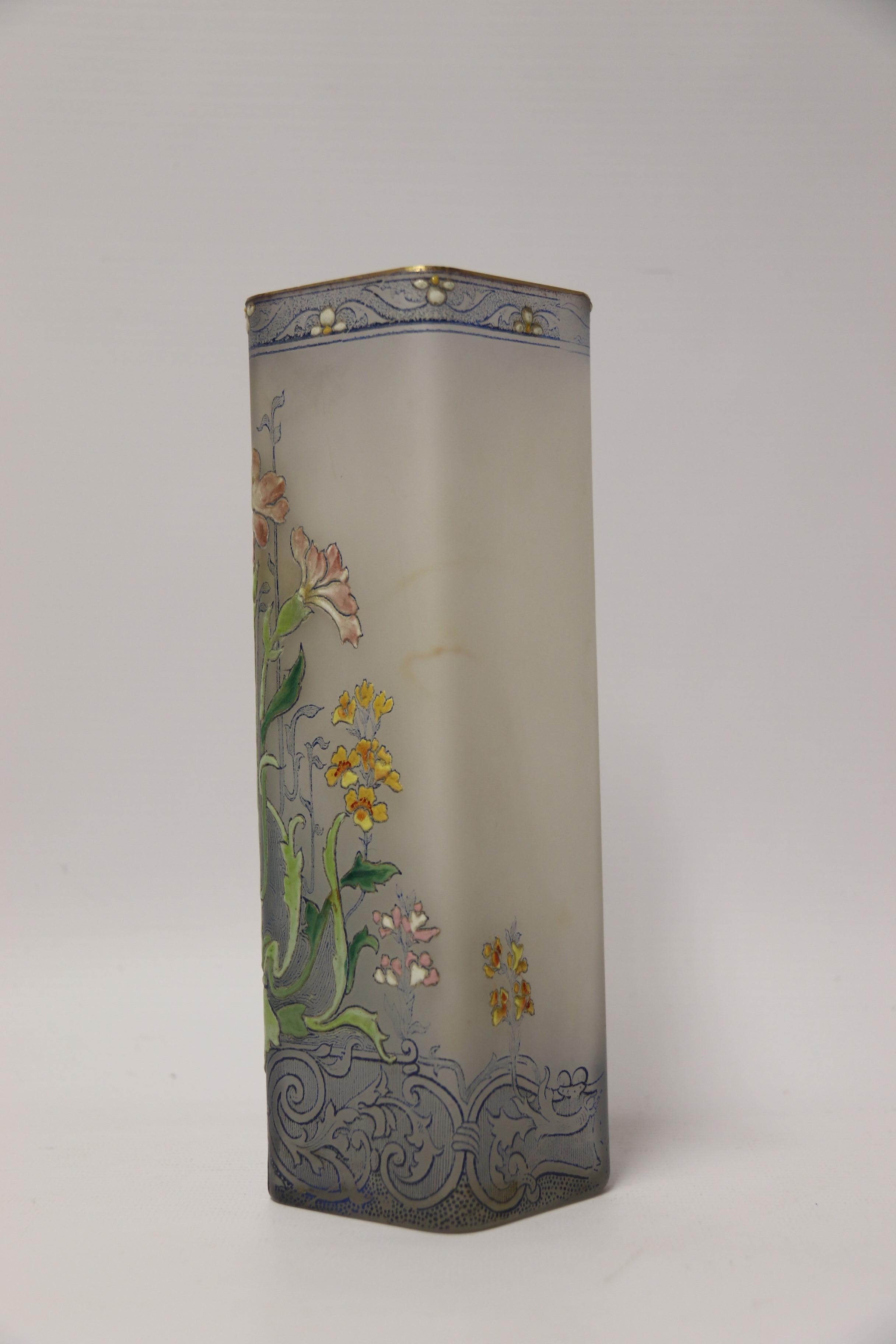 This unusual glass vase was most likely made at the French Legras factory. The vase is square in shape and made from clear glass with a frosted finish that is decorated with a folate blue printed design that forms the background decoration. Certain
