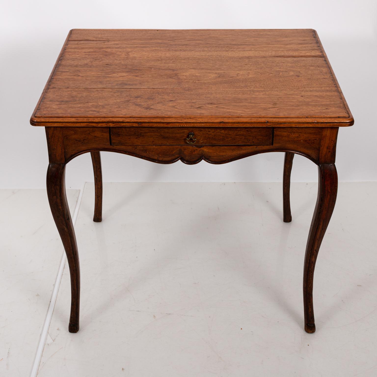 French fruitwood single drawer square table with cabriole legs, circa 1920s. The piece also features a single drawer with brass handle. Please note of wear consistent with age and use. Made in France.