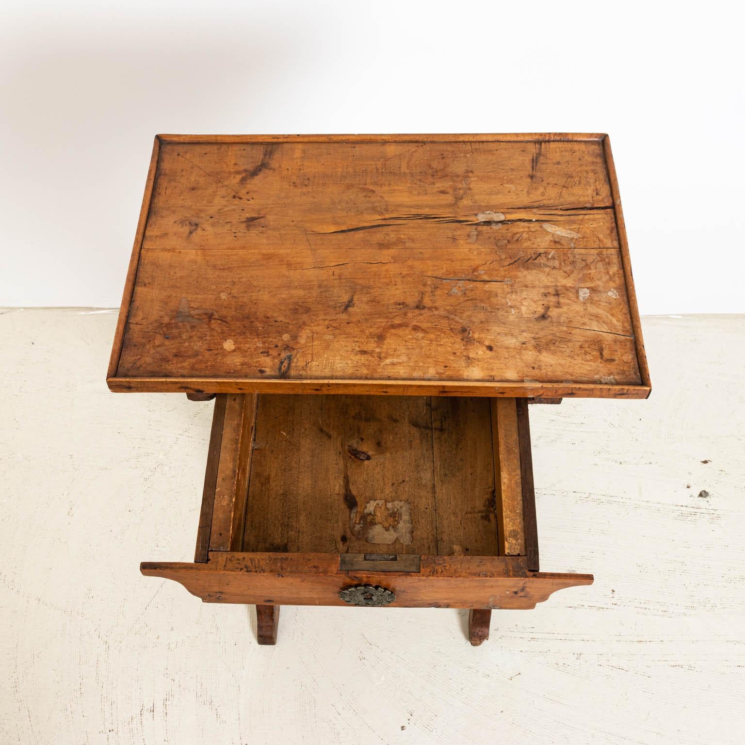 French fruitwood side table with drawer, circa 19th century. Please note of wear consistent with age including wear to top surface and scratches on top. There is also slight wear to finish throughout.