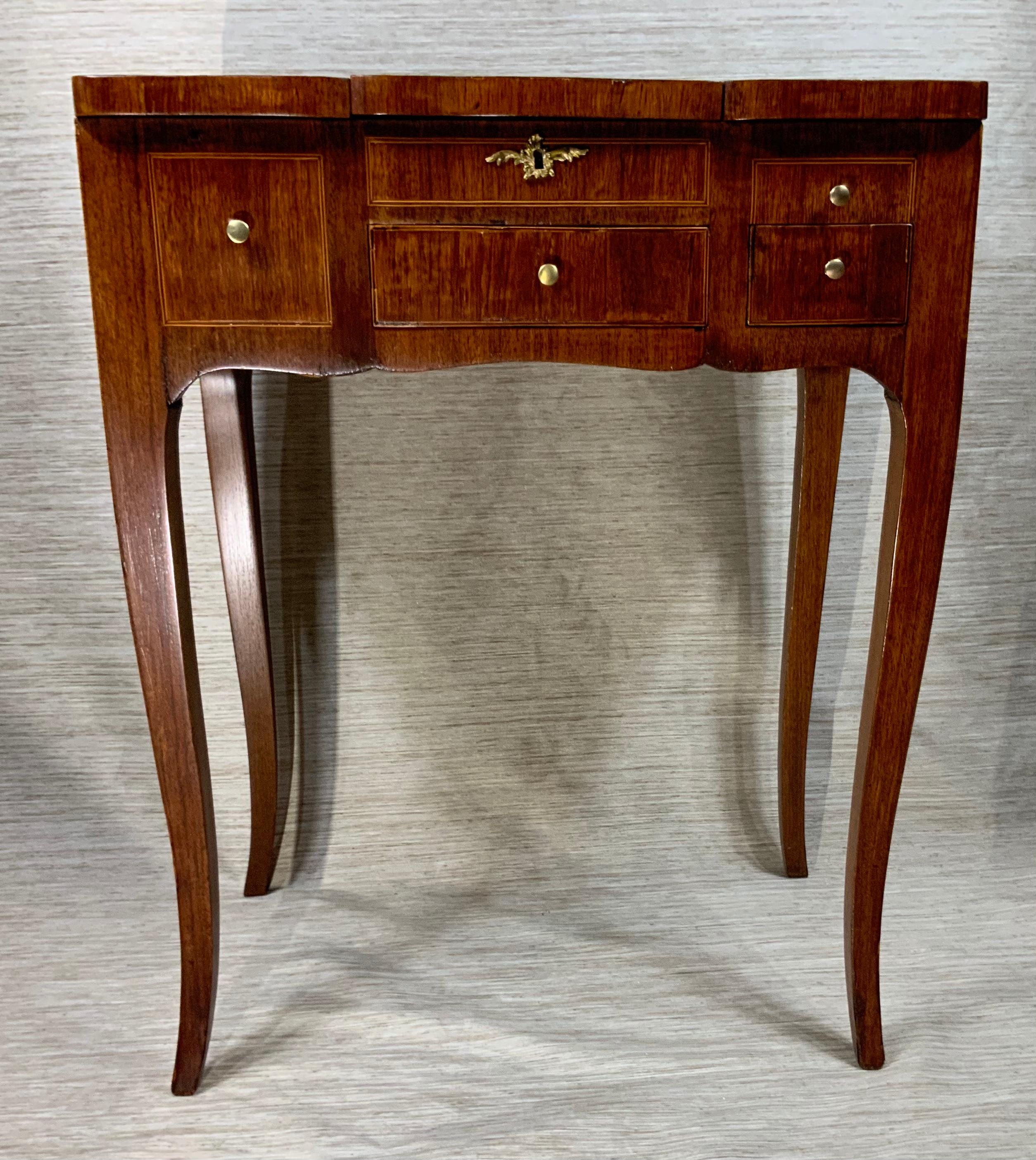 Antique vanity table made of walnut wood ,with beautiful inlaid fruitwood floral motif top. 
Two Draws , the top open to three compartments with the original floral silk layer .
A very nice professional restoration was made to make it ready to
